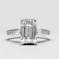 Front view of an emerald cut diamond solitaire ring in yellow gold.