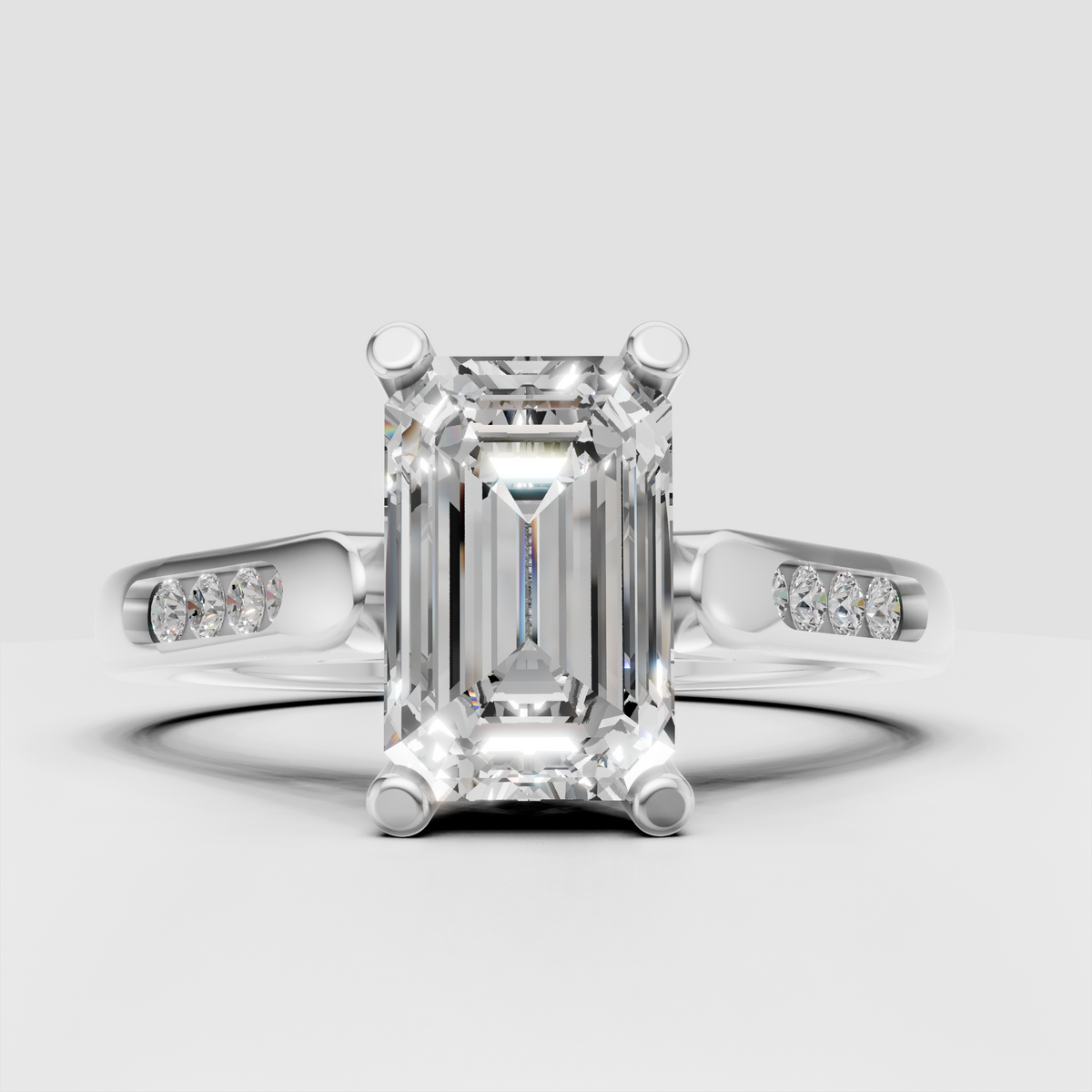 Front view of an emerald cut diamond solitaire ring in yellow gold.
