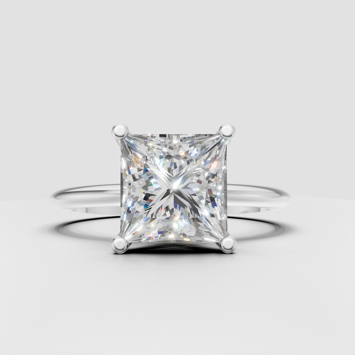 Princess cut diamond engagement ring with four rounded prongs and minimalist polished shank