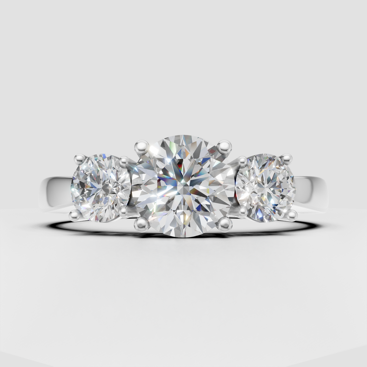 Round Diamond three-stone ring with polished yellow gold band