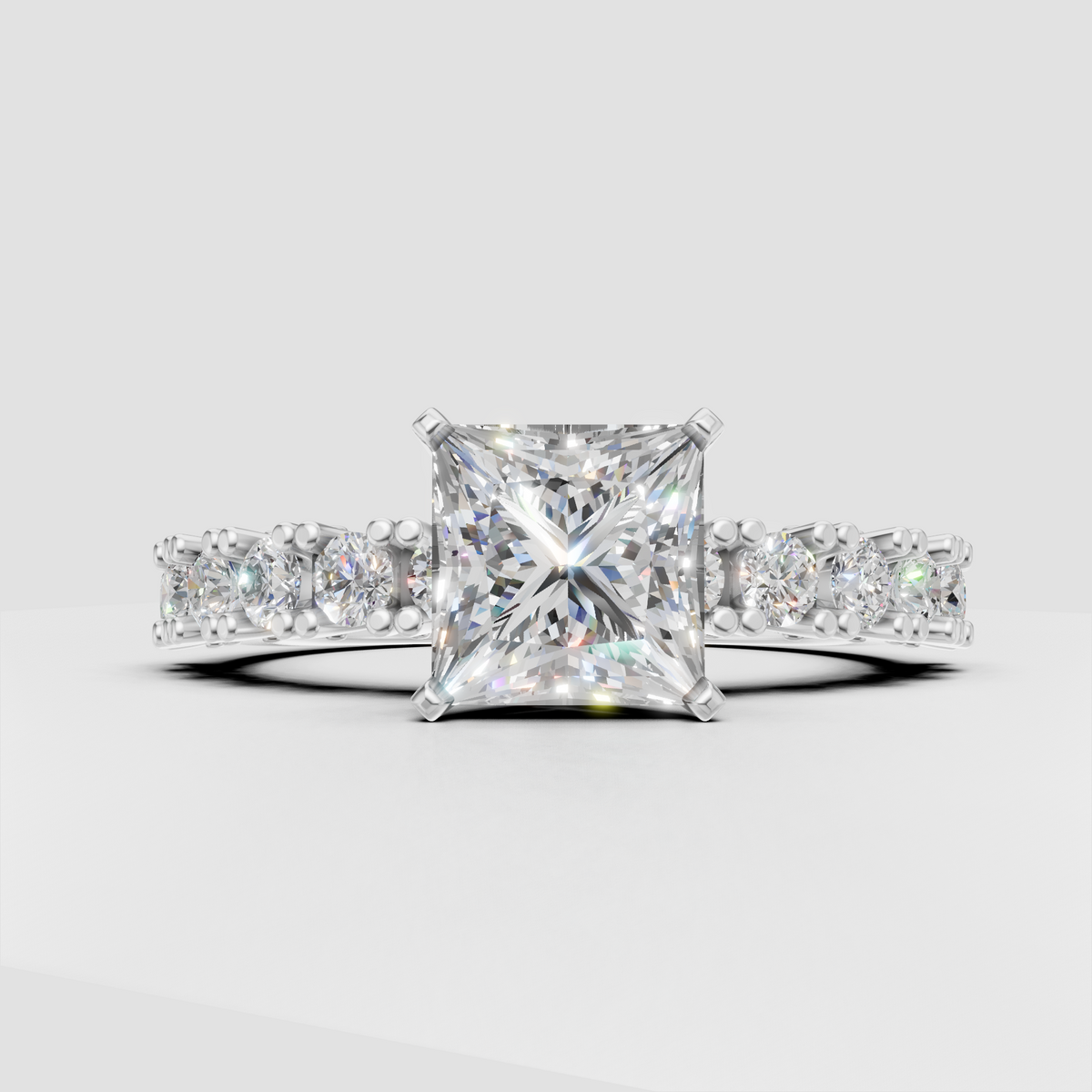 Four-prong princess cut diamond engagement ring with half-eternity side stones