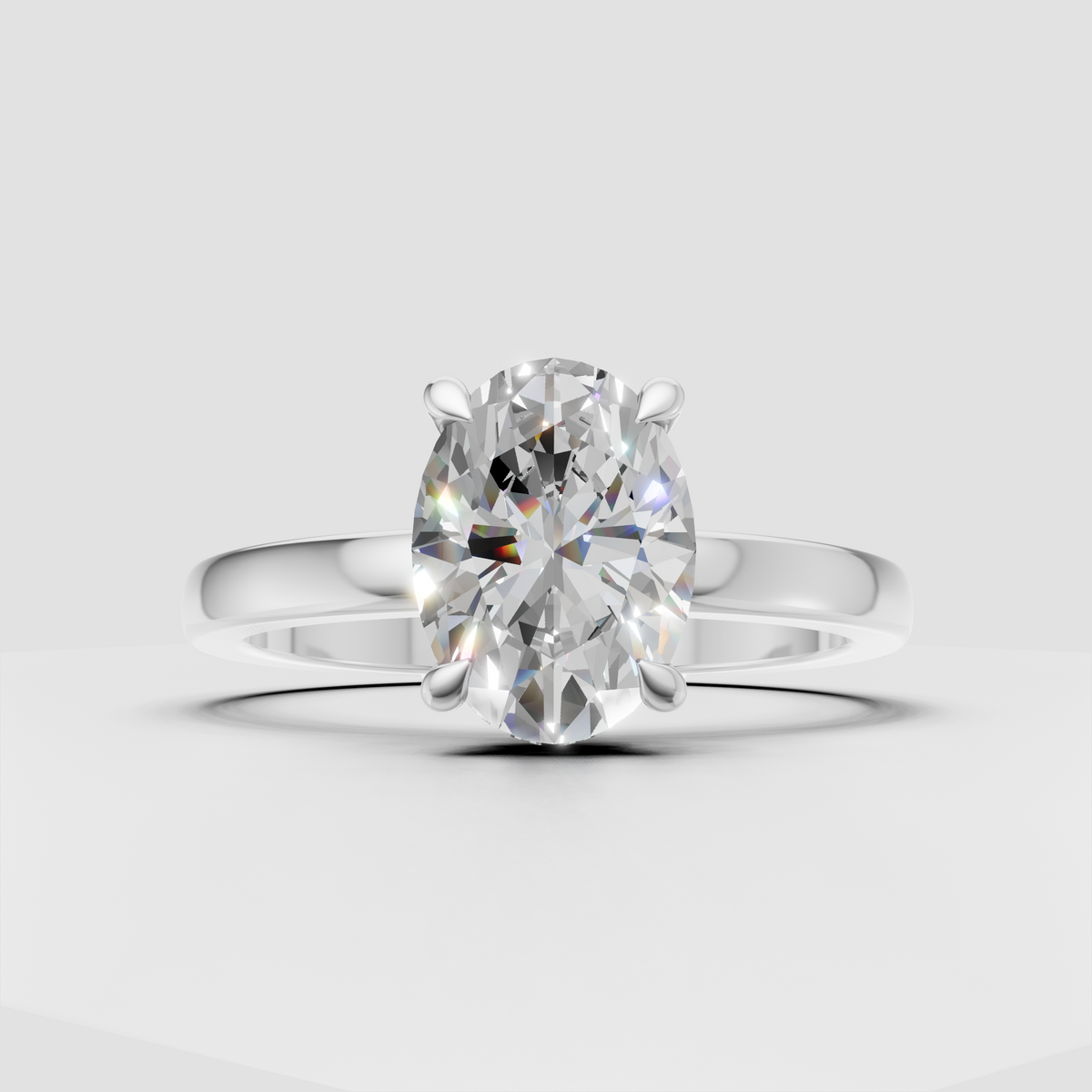 Four-prong oval diamond engagement ring with concealed halo