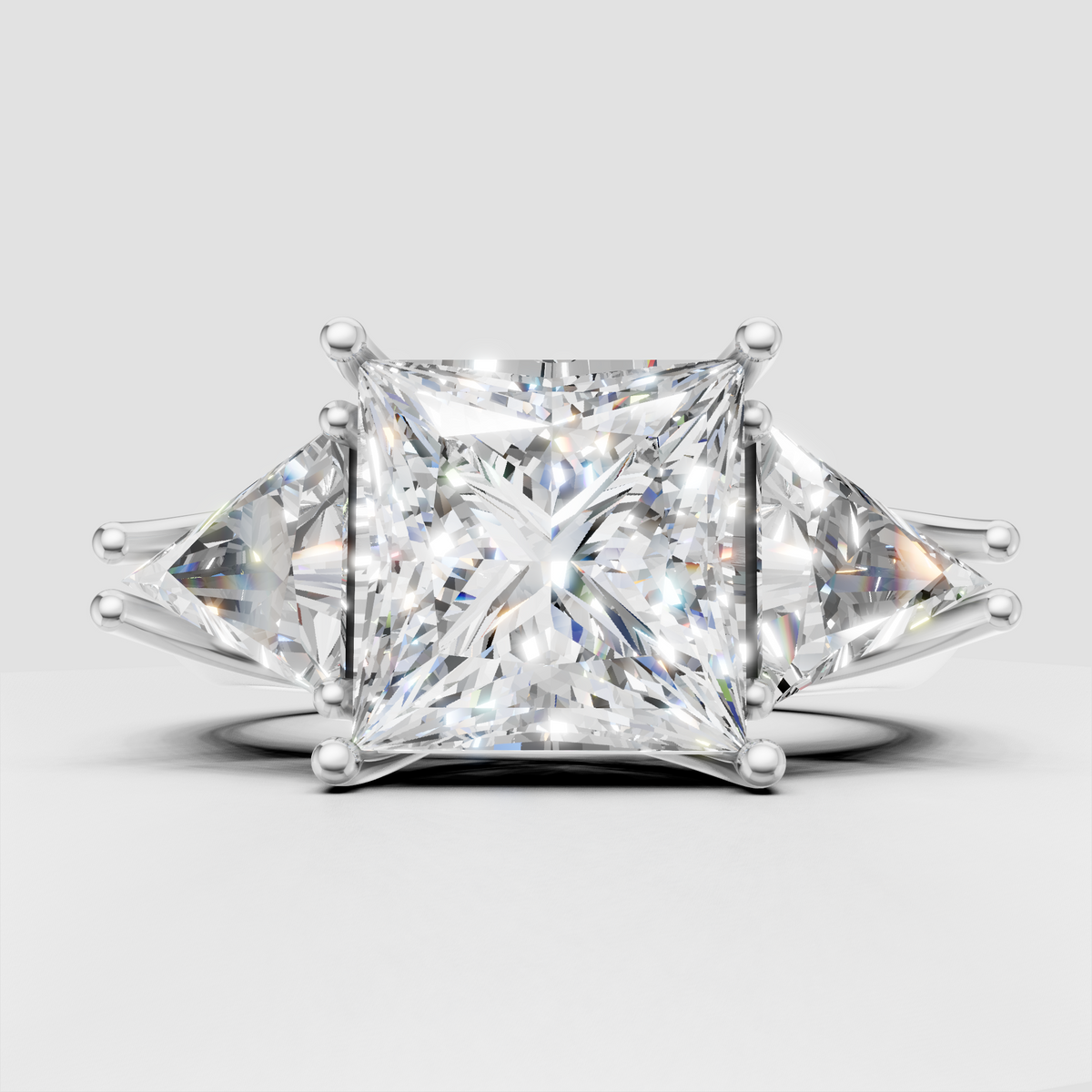 Princess diamond three stone engagement ring with yellow gold prongs