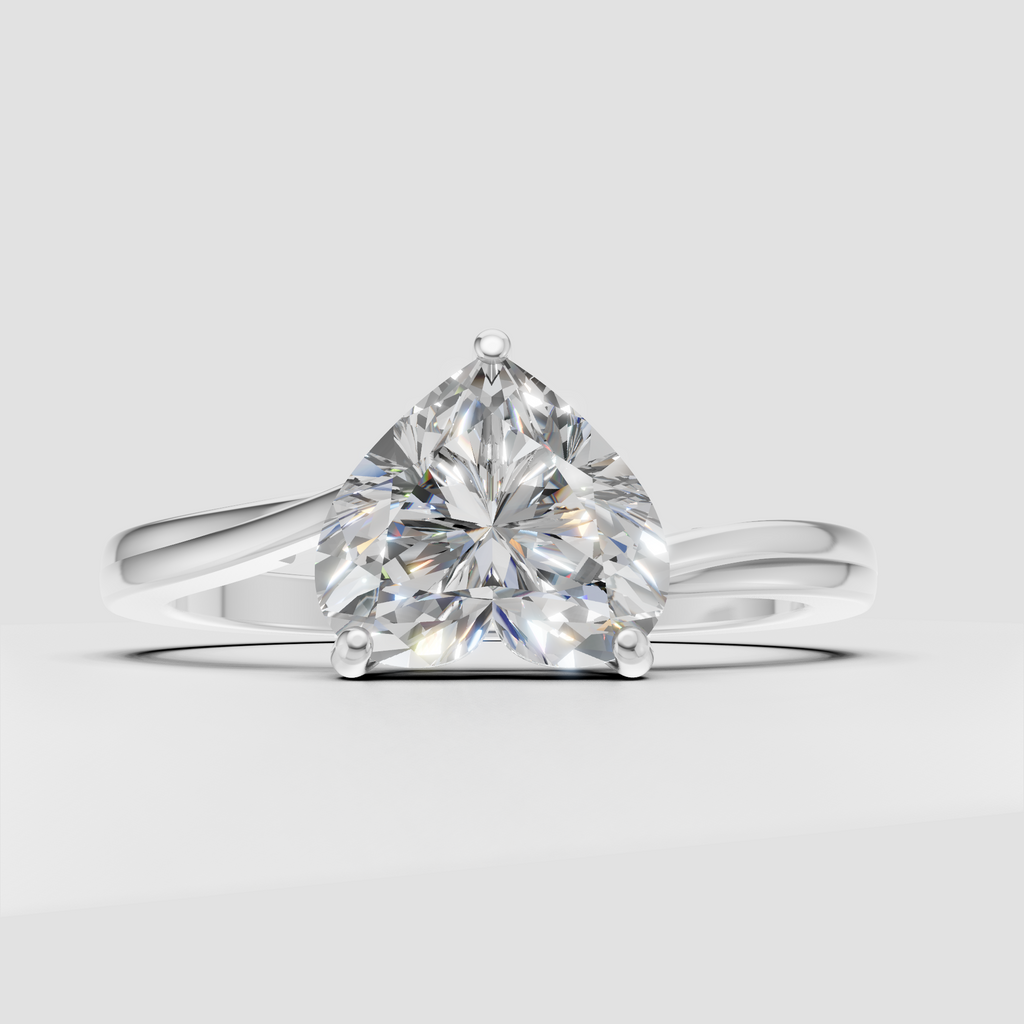 Heart shaped center stone secured by four polished yellow gold prongs