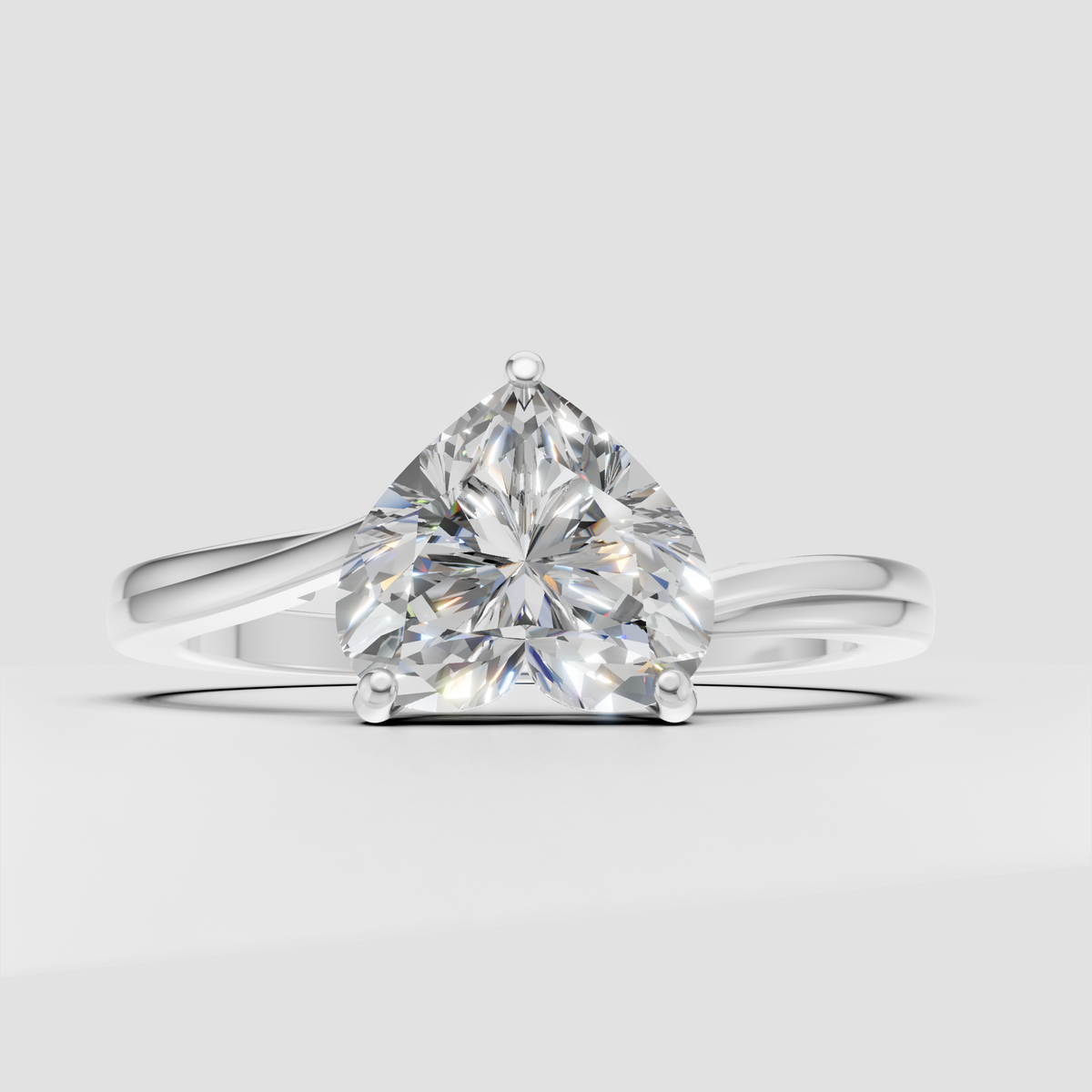 Heart shaped center stone secured by four polished yellow gold prongs