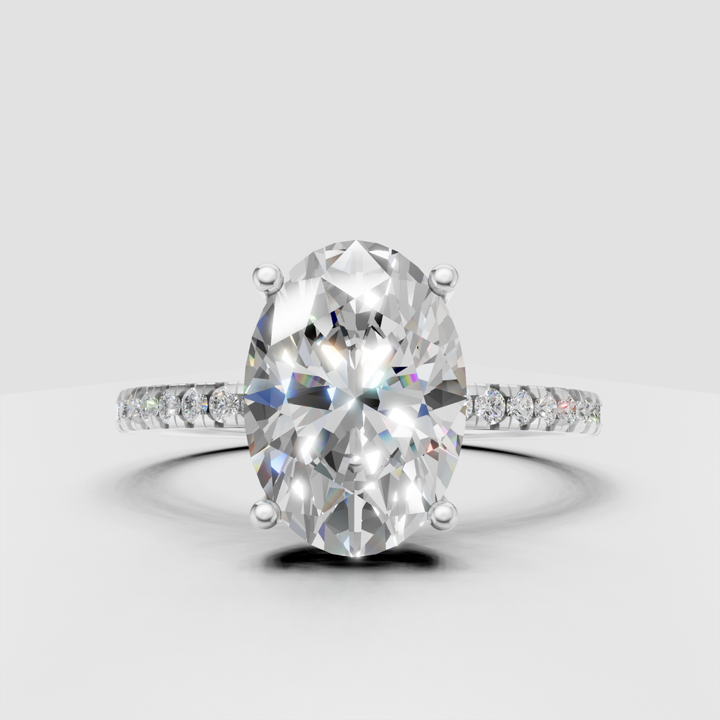 Oval diamond ring featuring a slim pavé diamond band