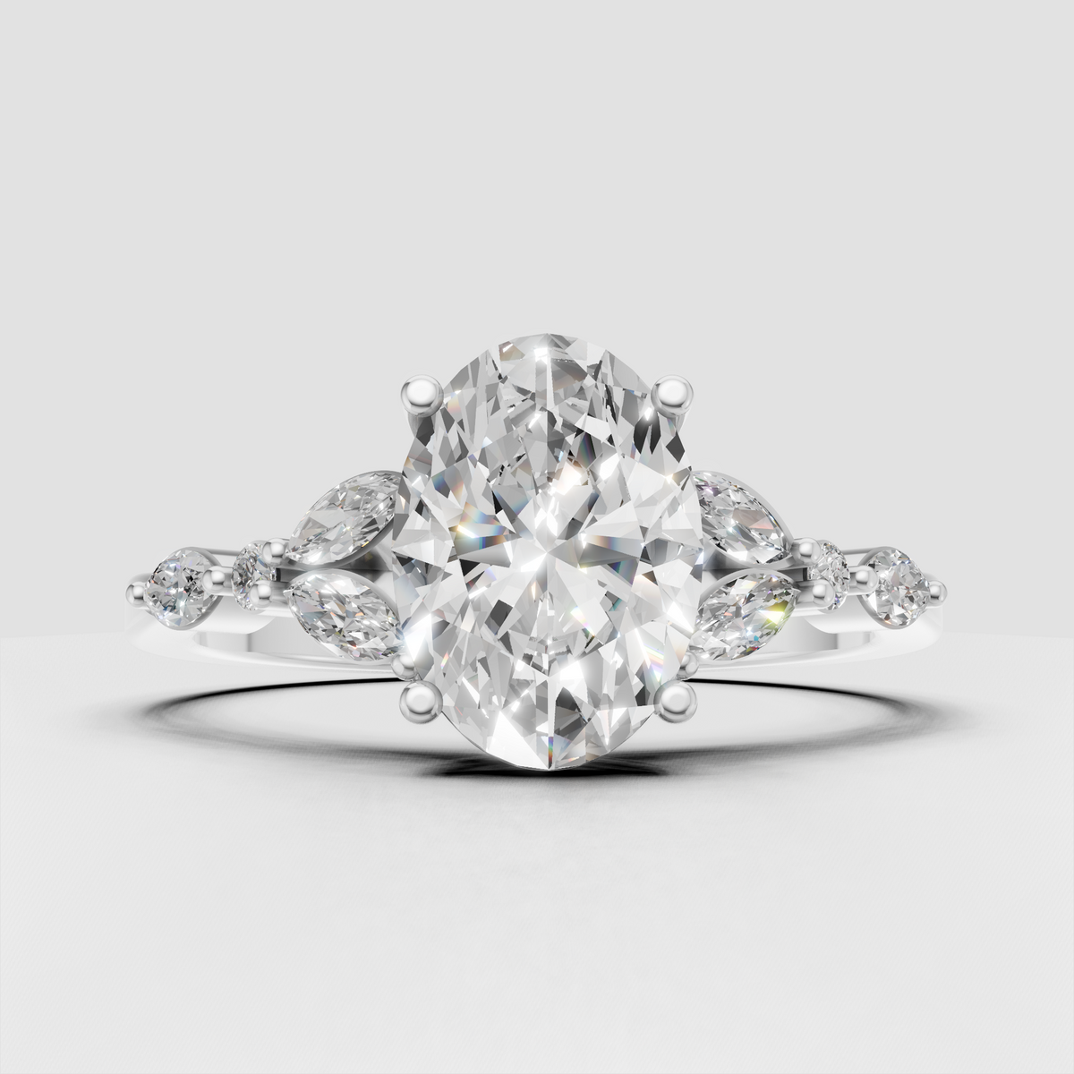 Oval diamond ring featuring marquise-shaped side stones and round accents