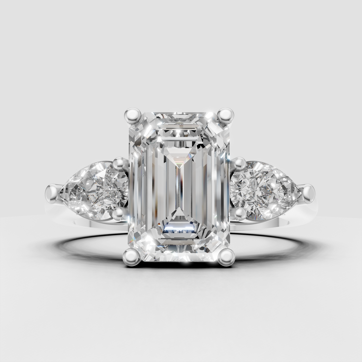 Emerald and pear diamond ring in yellow gold