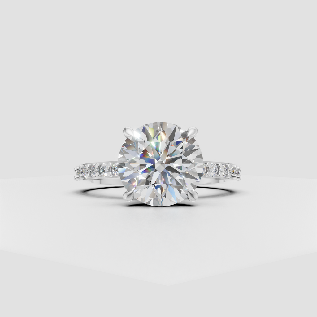 Round brilliant diamond engagement ring with delicate pavé shoulders