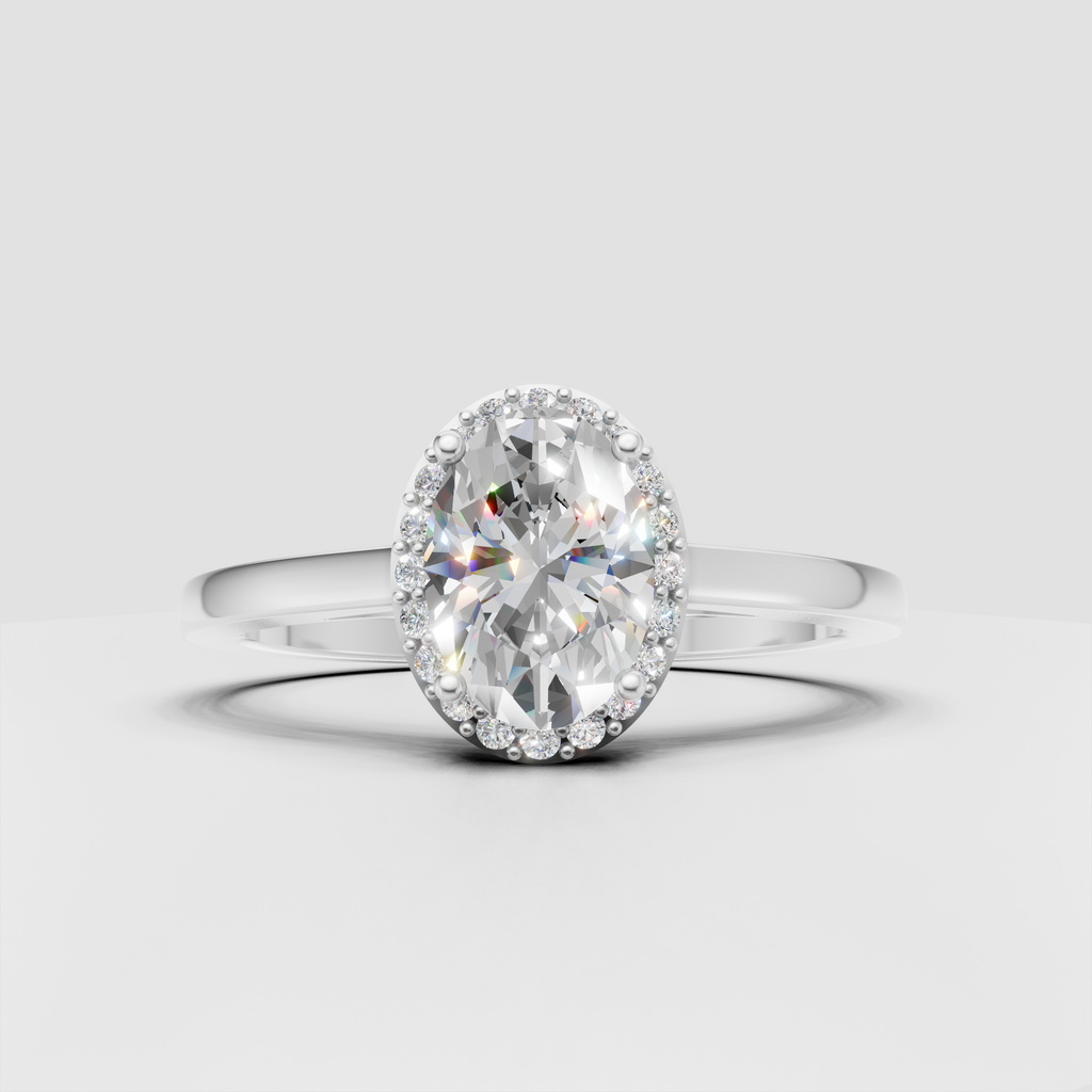 Oval diamond ring featuring a polished yellow gold band and halo