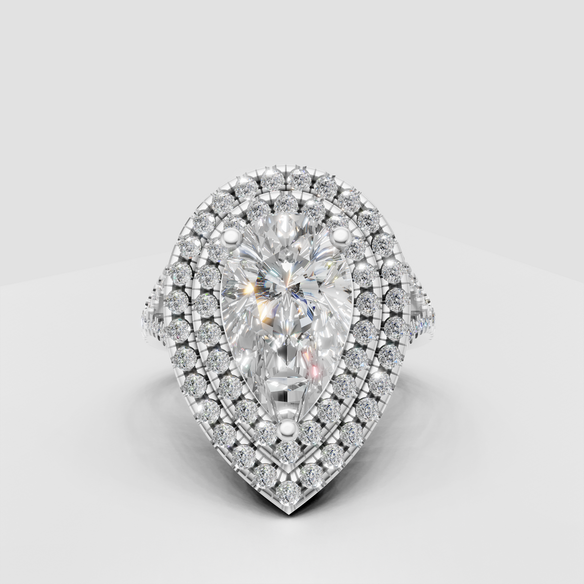 Pear cut diamond ring featuring four-prong center setting
