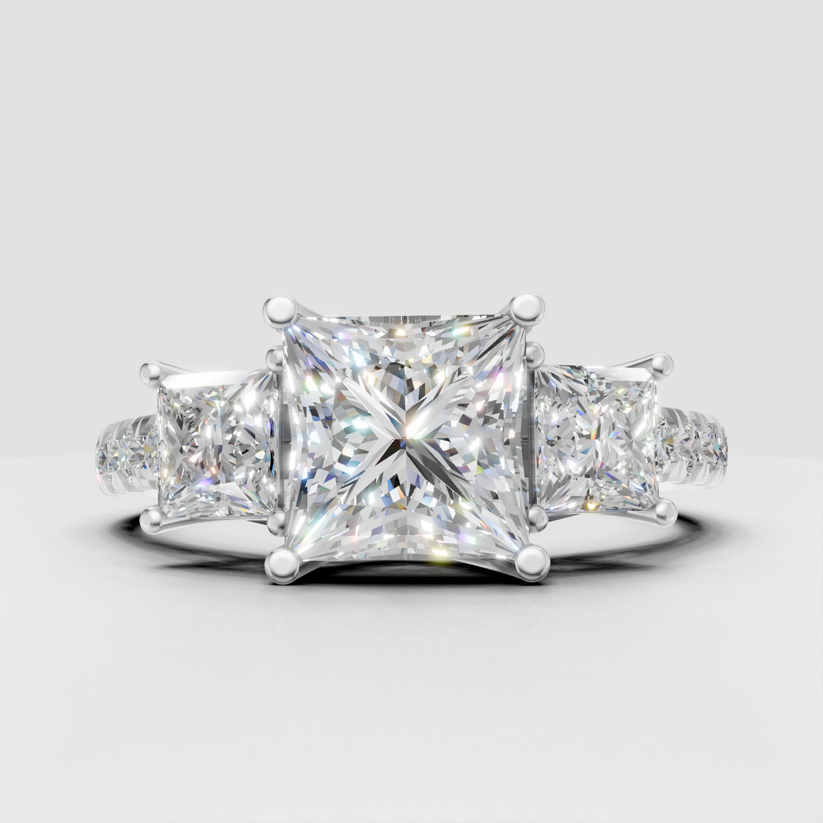 Princess cut canter diamond with two matching side stones