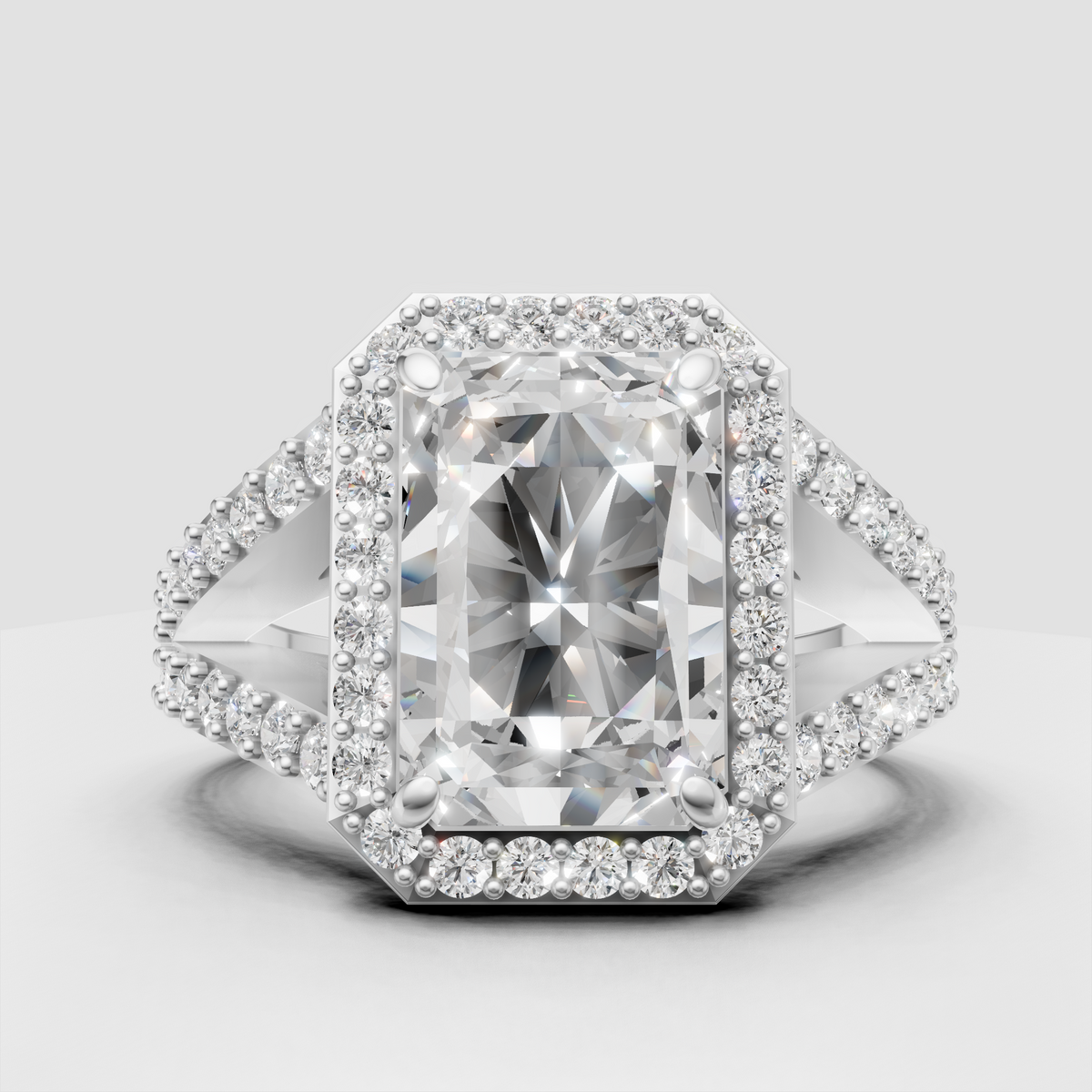 Radiant cut diamond ring featuring split shank shoulders