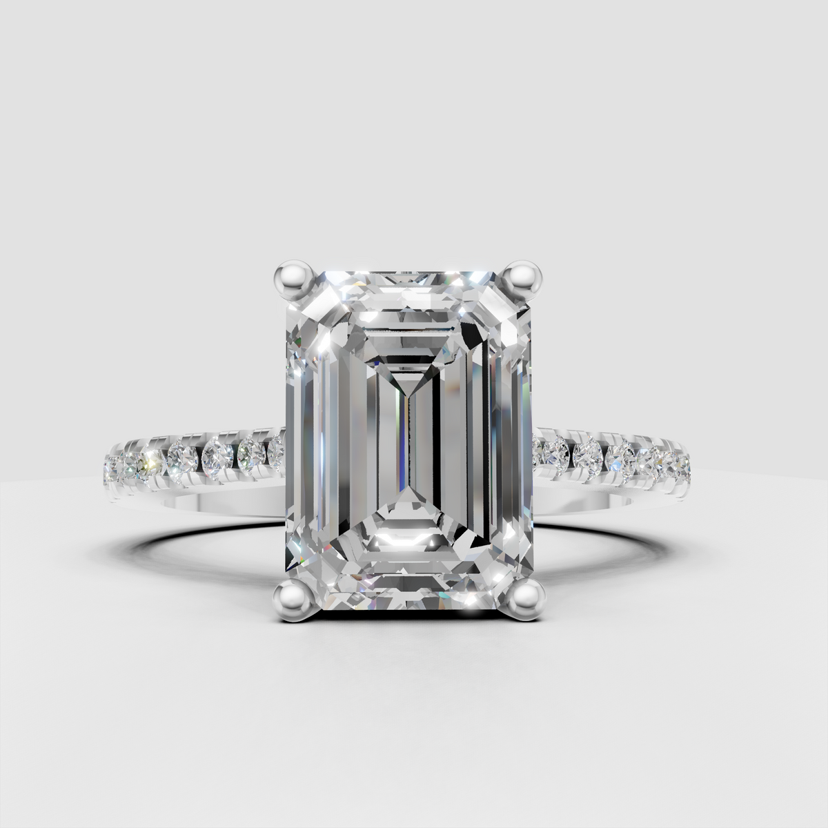 Emerald diamond engagement ring featuring a four prong setting