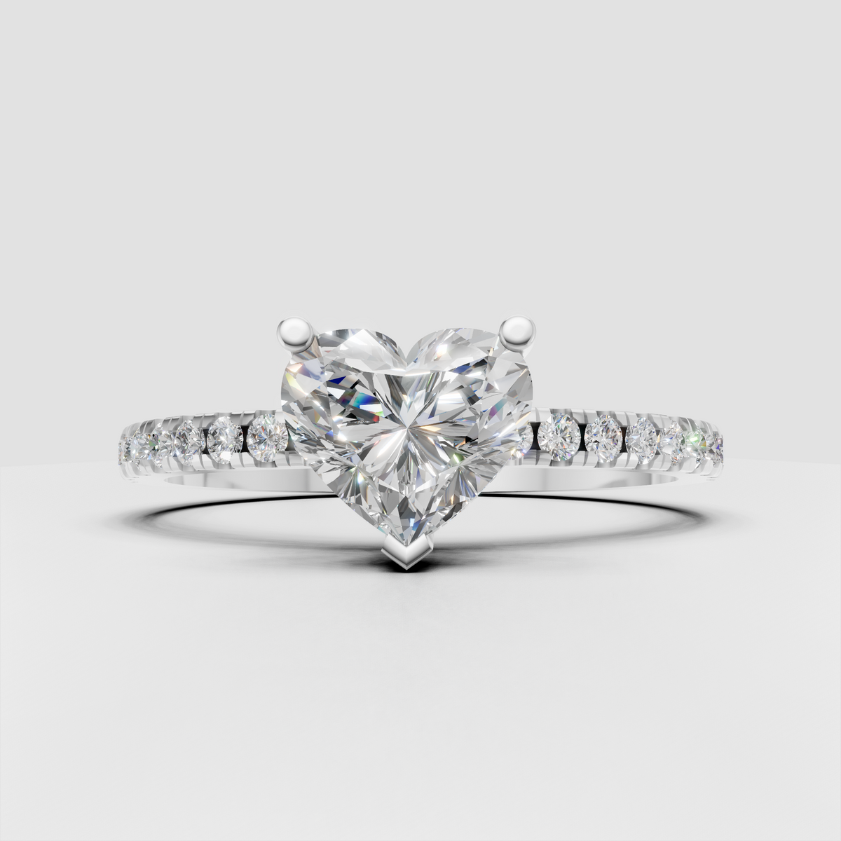 Heart cut diamond ring featuring a pavé diamond band