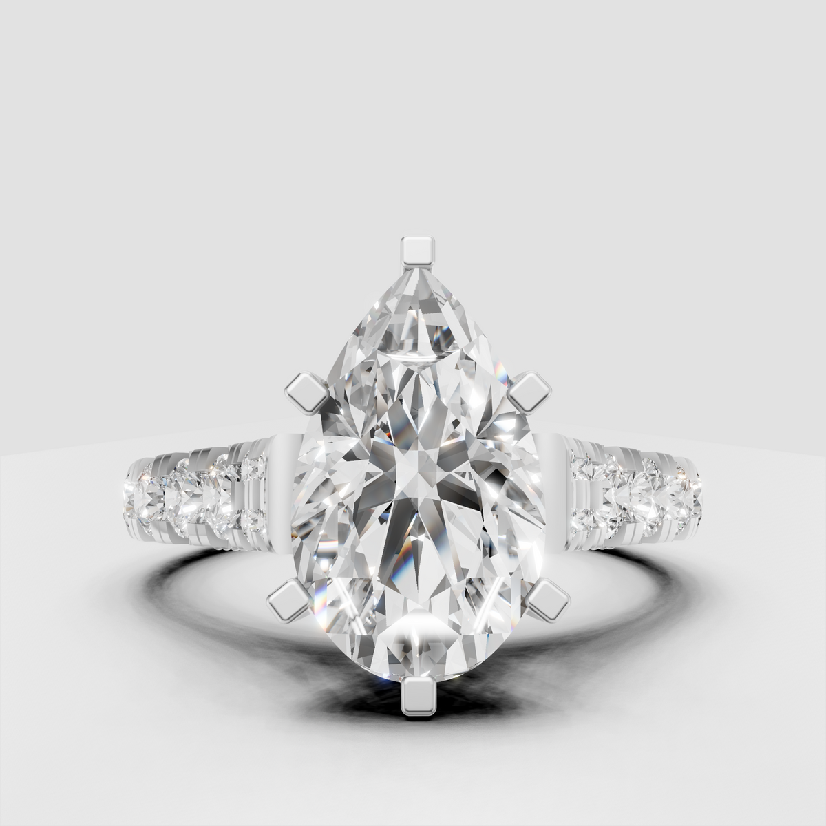 Pear cut engagement ring with pavé diamond-accented shoulders