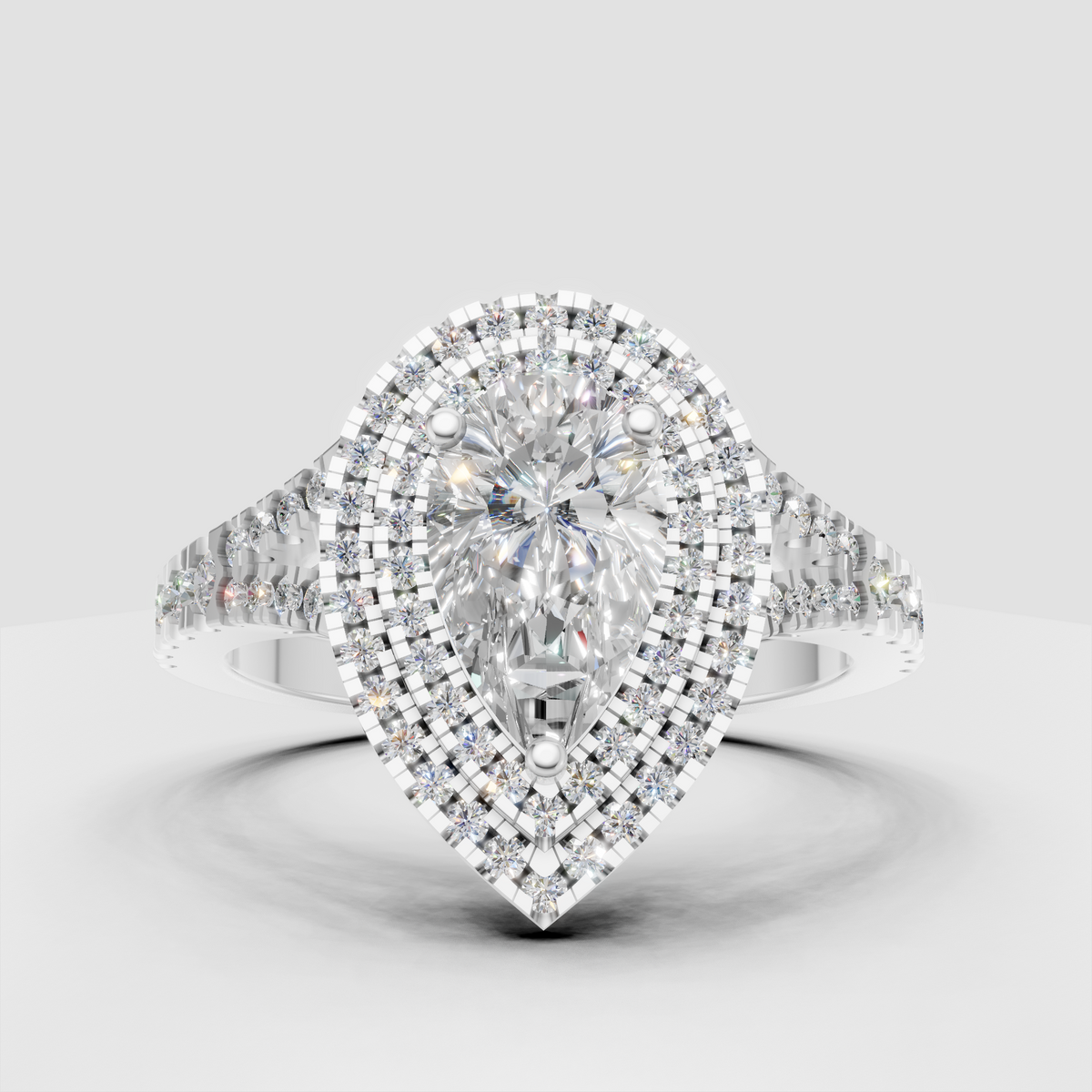 Triple halo pear diamond ring with split-shank shoulders