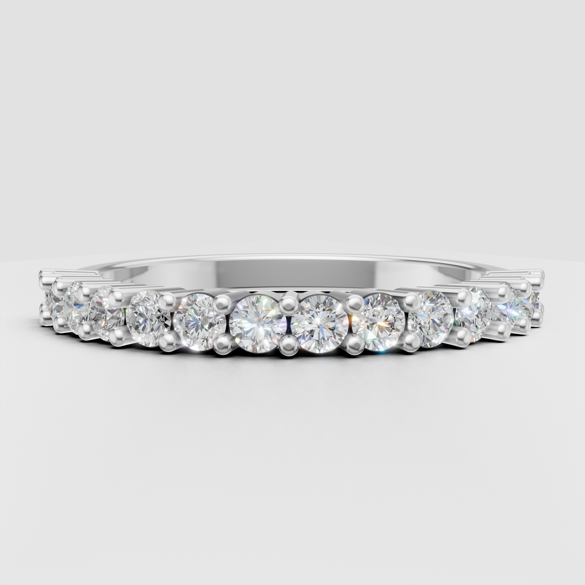 Polished gold ring featuring a row of round brilliant diamonds