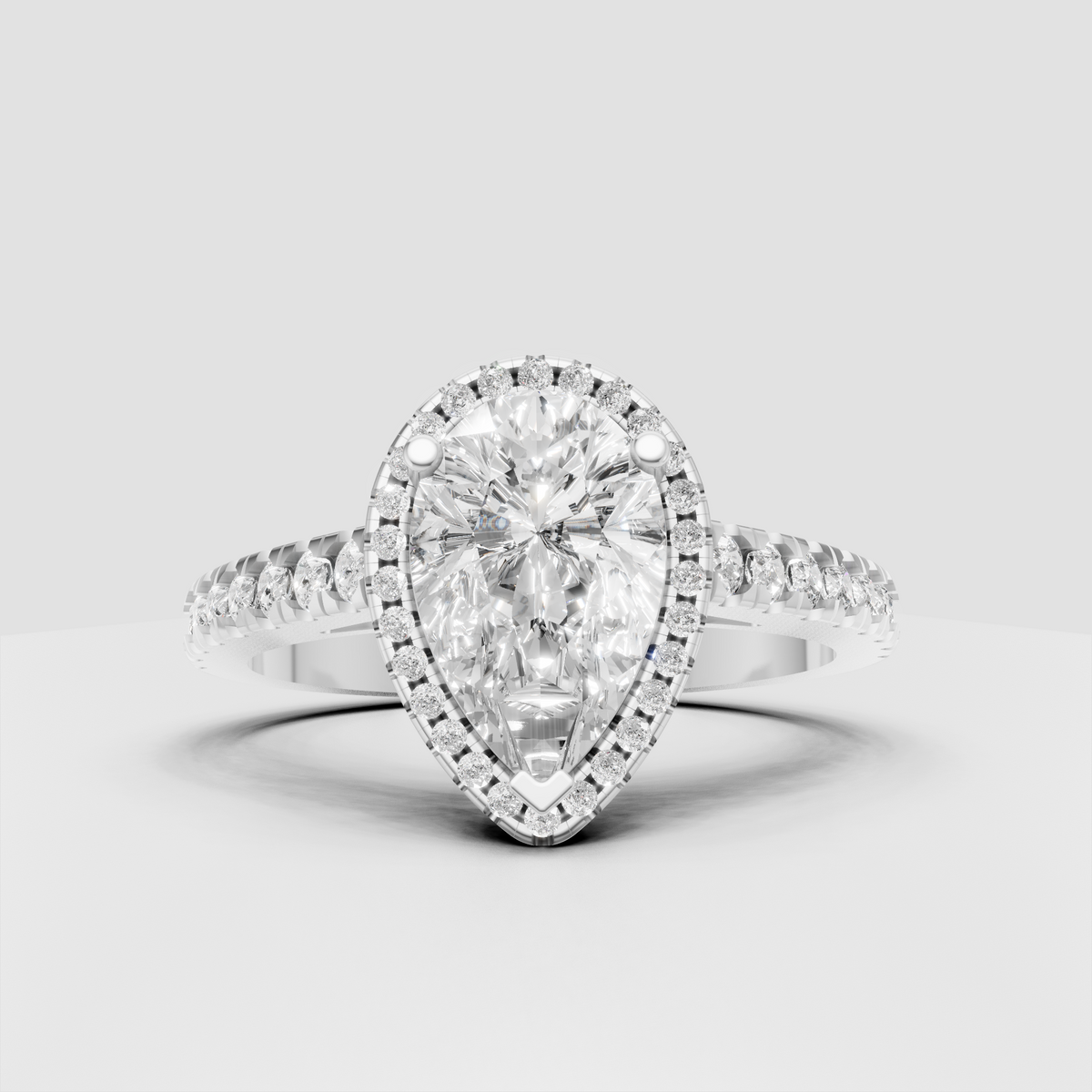 Pear cut diamond ring featuring a full halo of round accent stones