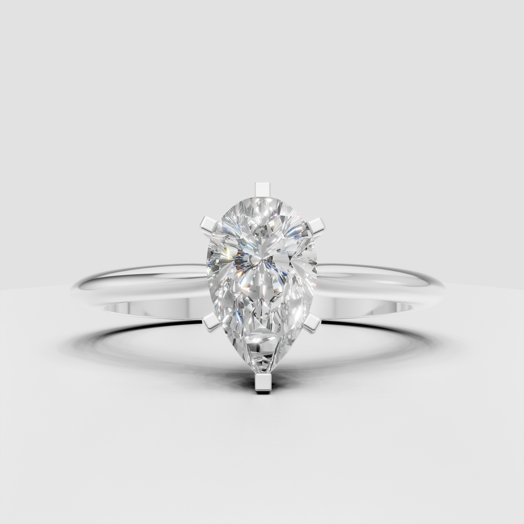 Pear shaped solitaire engagement ring with cathedral shoulders