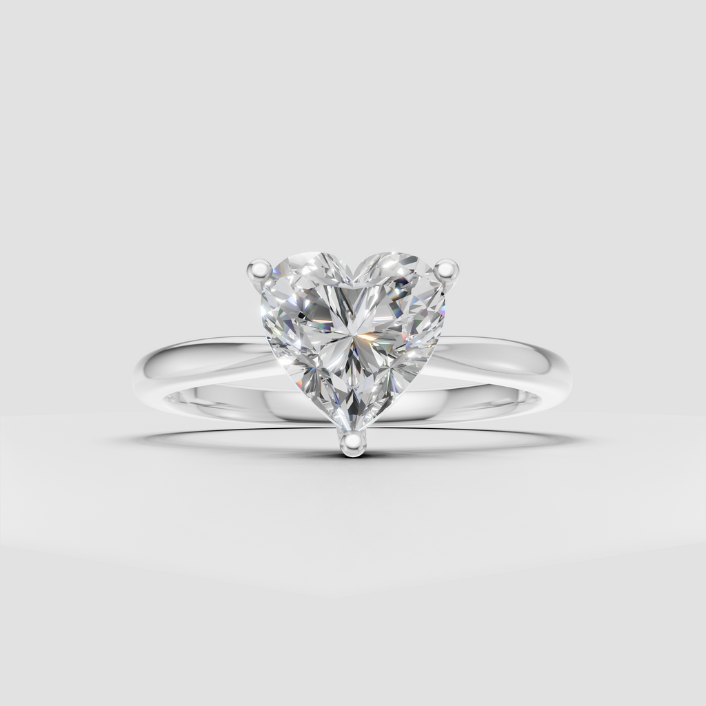 Heart shaped solitaire engagement ring with elegant yellow gold setting