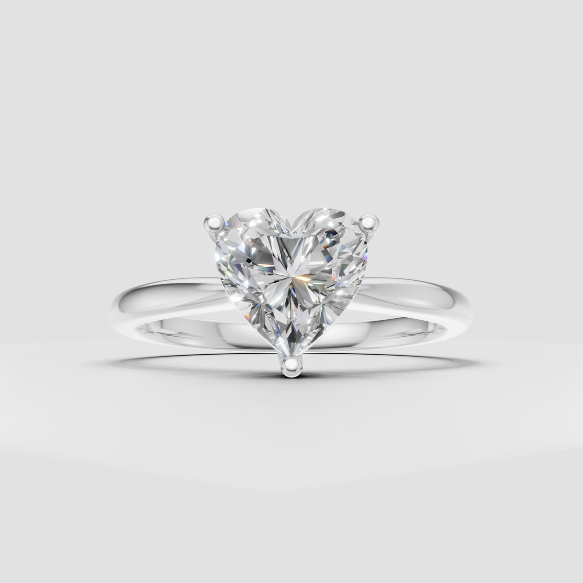 Heart shaped solitaire engagement ring with elegant yellow gold setting