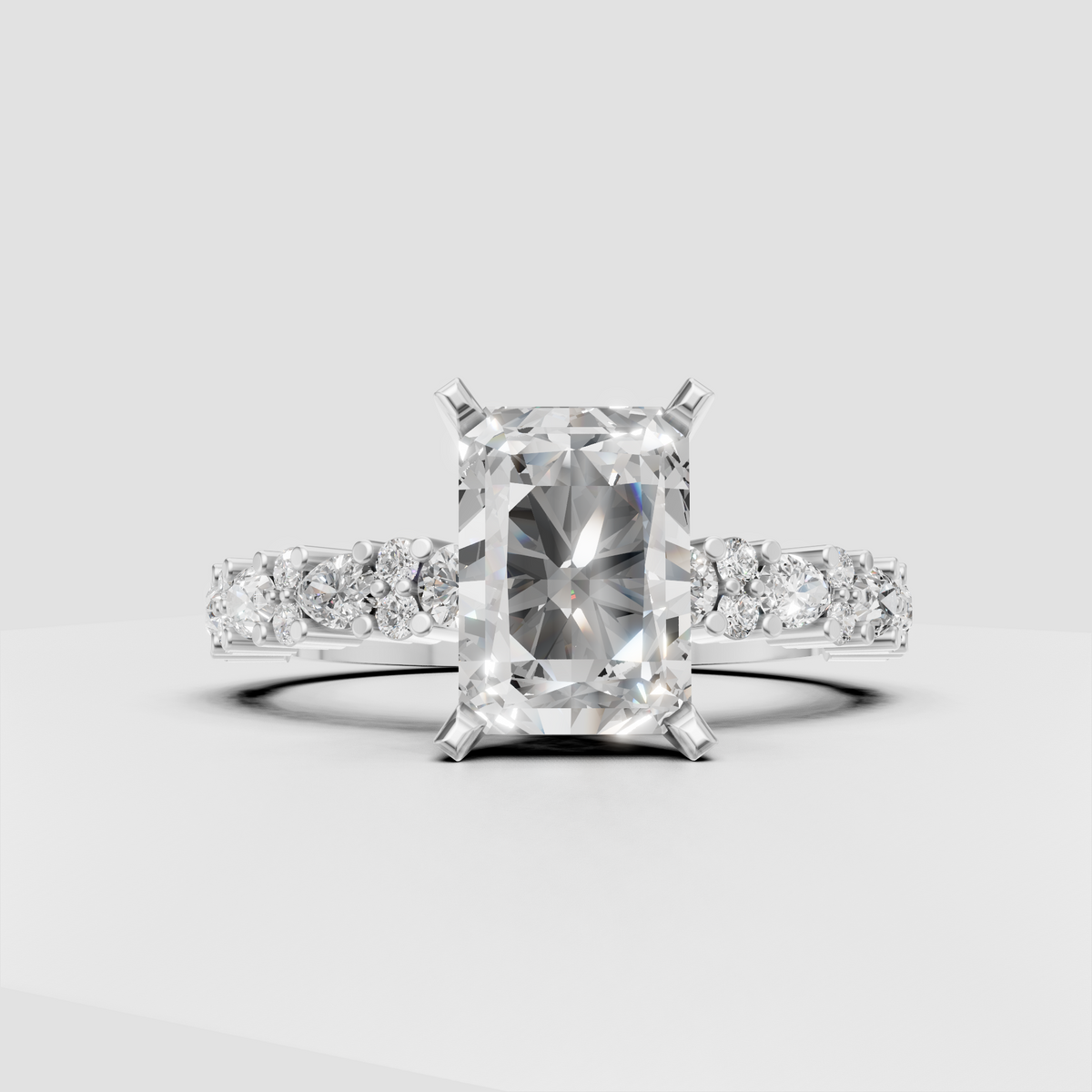 Radiant cut diamond solitaire with brilliant accent stones along the band