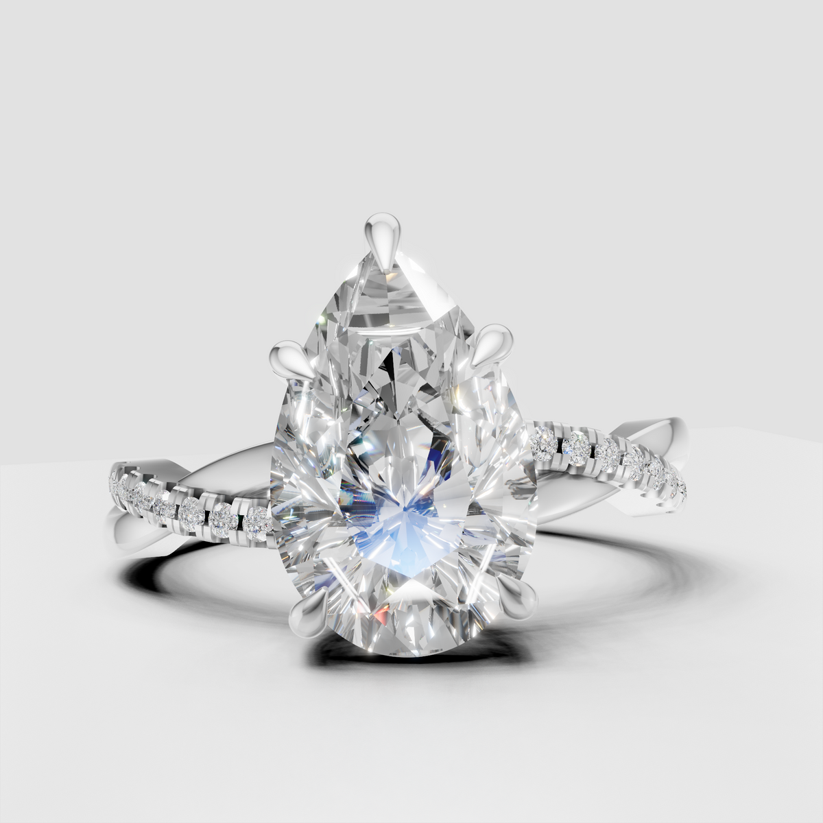 Pear cut engagement ring with delicate round diamonds
