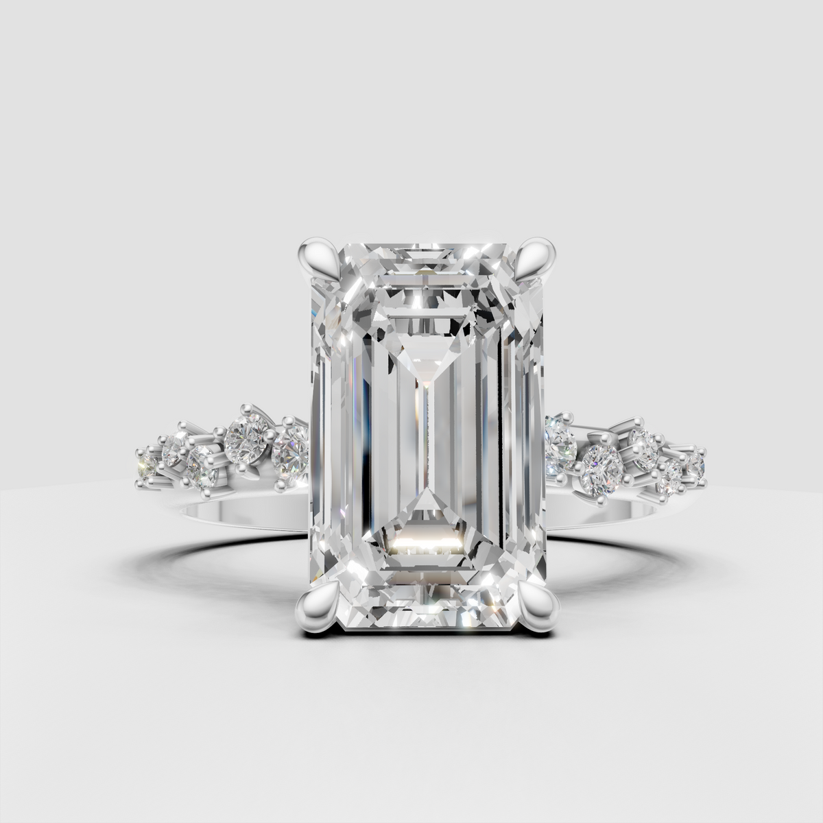 Emerald cut center diamond with graduated pavé accent stones
