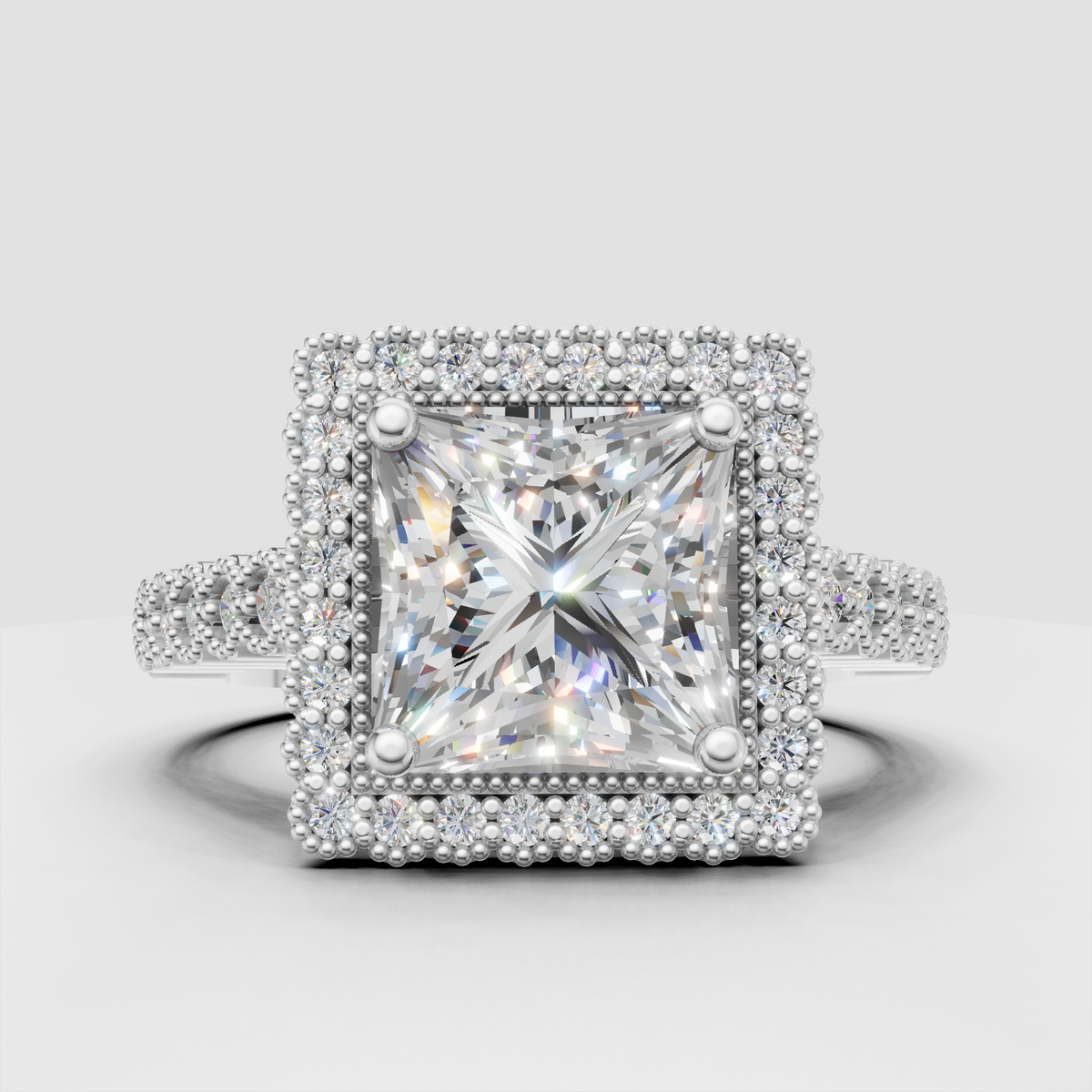 Princess diamond engagement ring with four-prong center and halo setting