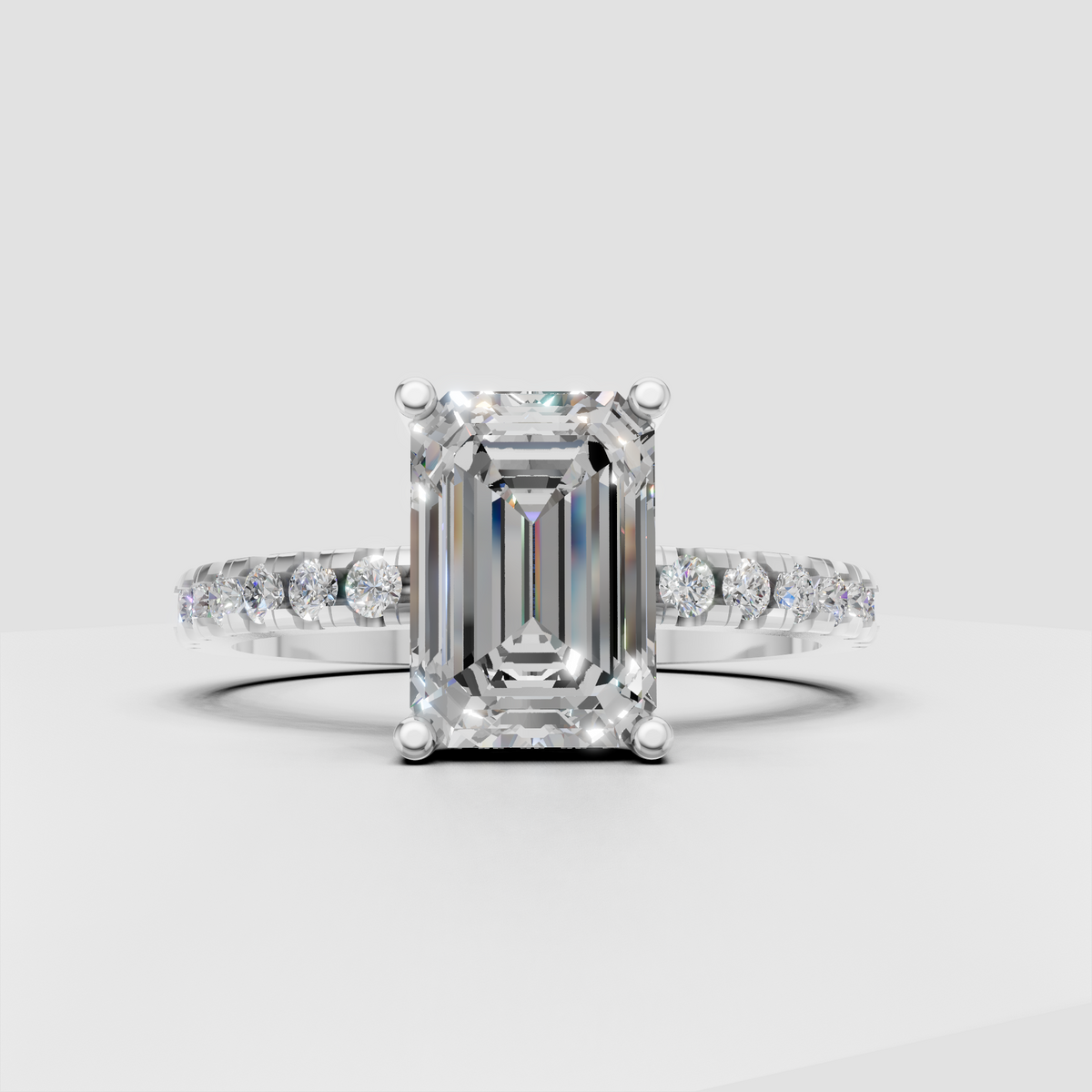 Elegant emerald diamond engagement ring with pavé band
