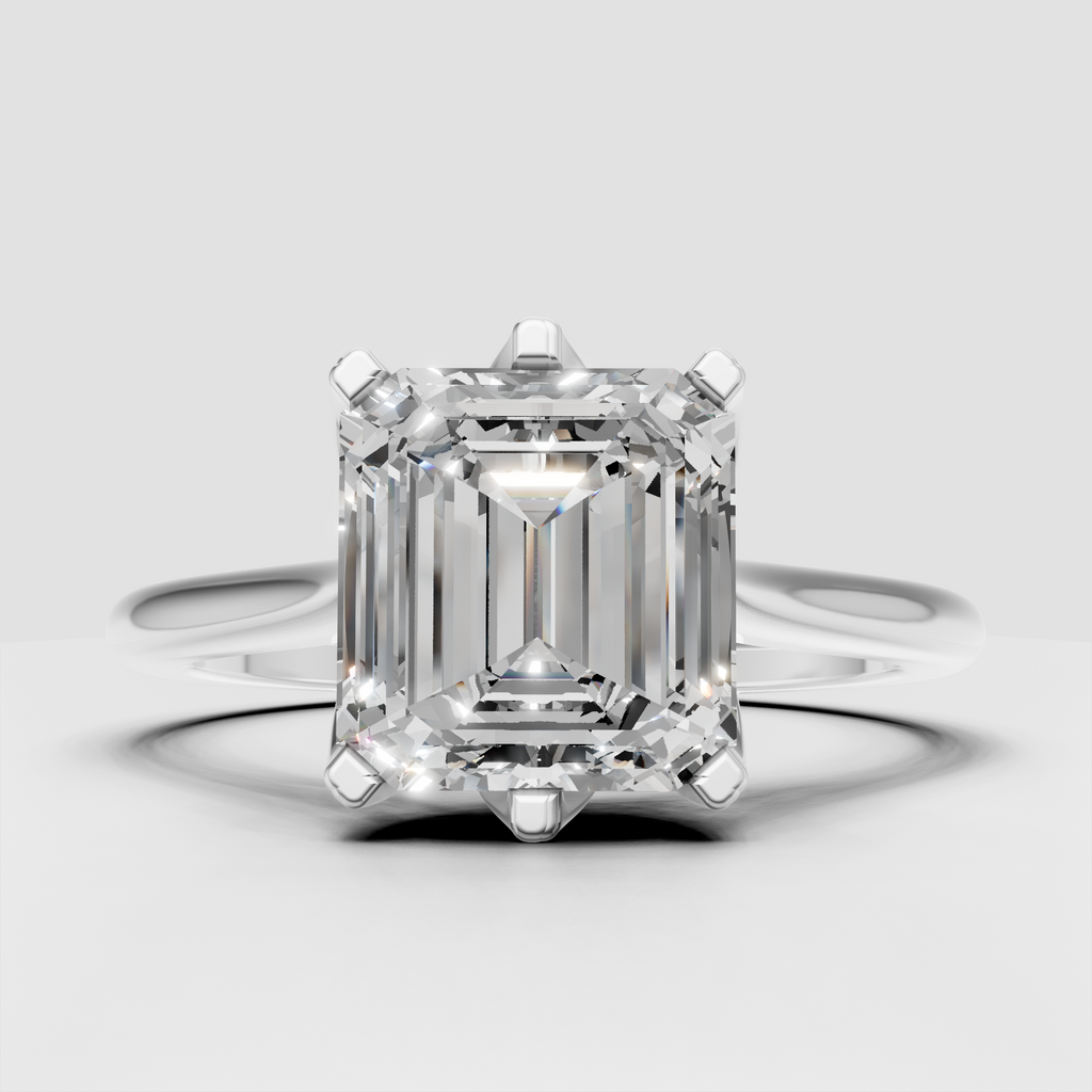 Emerald cut engagement ring featuring a polished yellow gold band