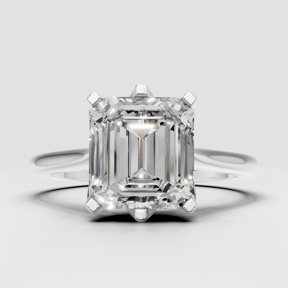 Emerald cut engagement ring featuring a polished yellow gold band