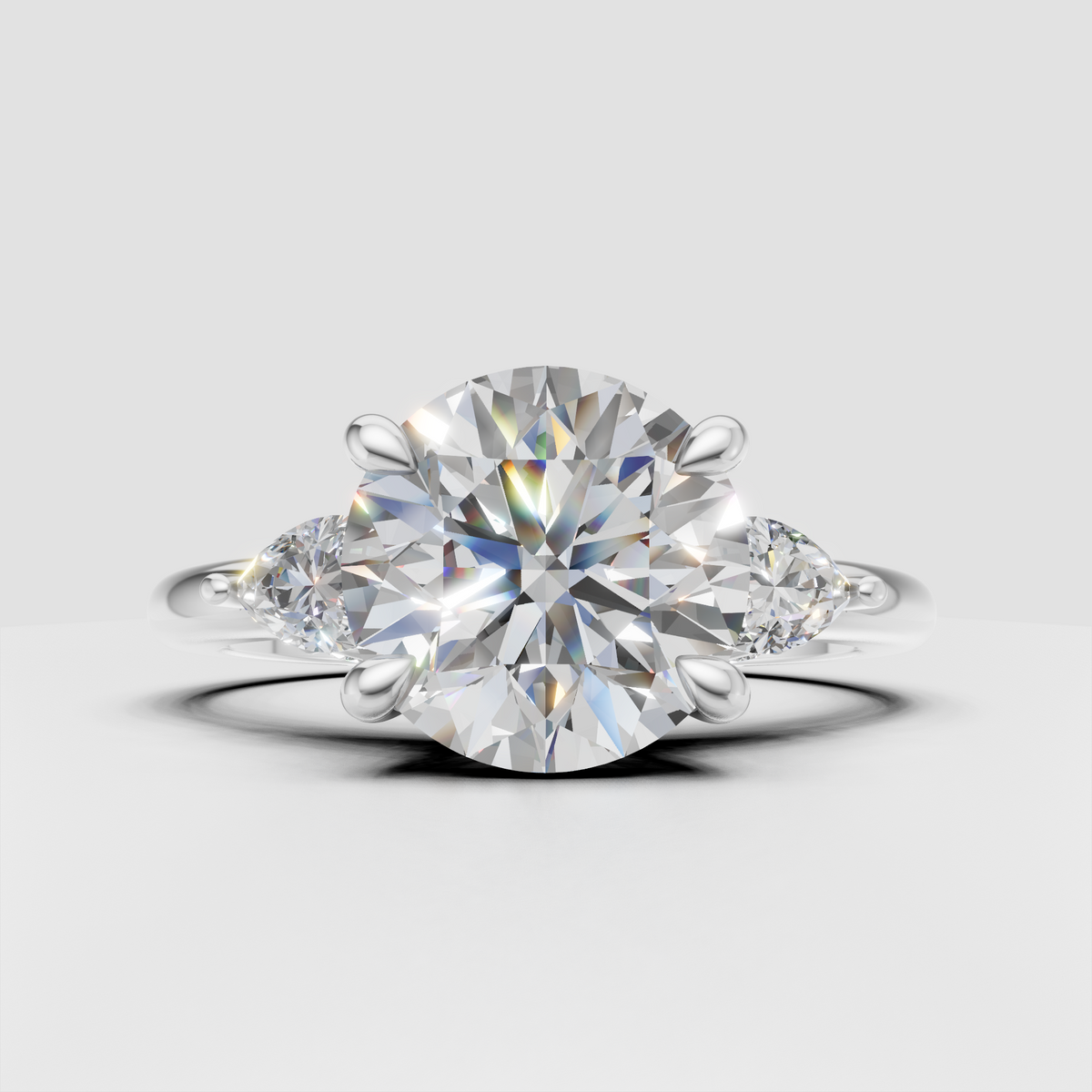 Round canter diamond ring with pear side stones