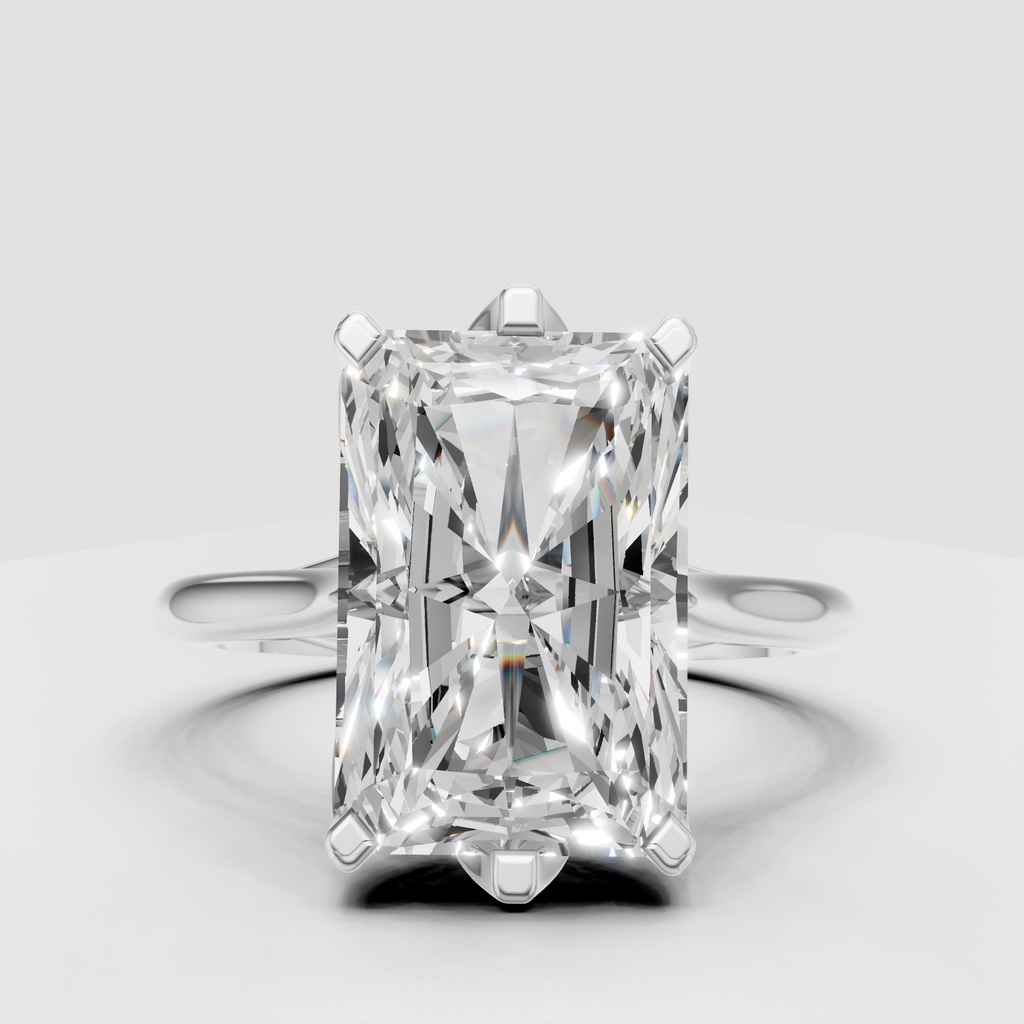 Radiant diamond solitaire ring featuring a polished gold band
