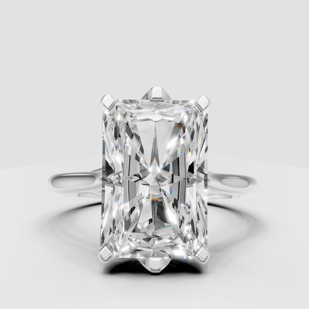 Radiant diamond solitaire ring featuring a polished gold band