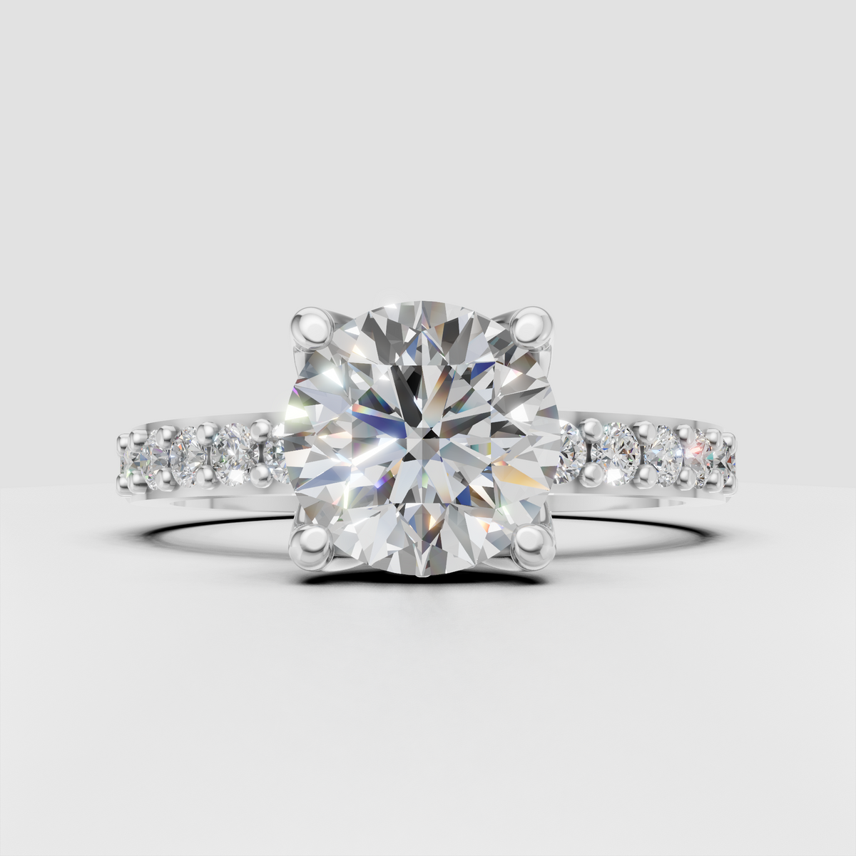 Floral-inspired round diamond engagement ring with pavé side stones