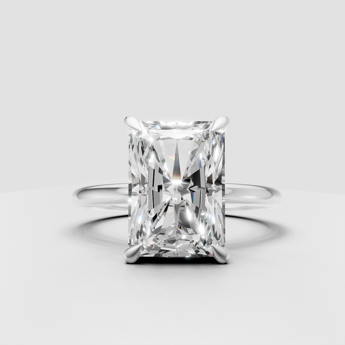 Radiant cut diamond ring featuring hidden round stone halo