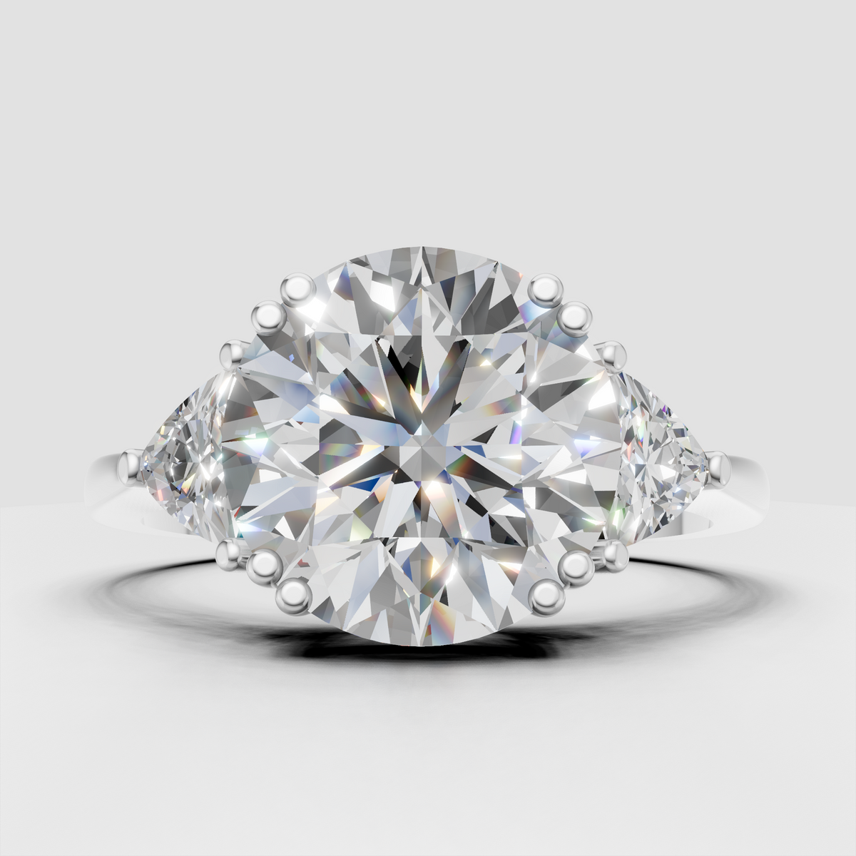 Round-cut diamond engagement ring with elegant pear side stones