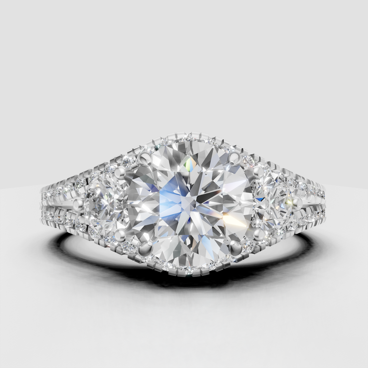 Yellow gold three stone engagement ring with pavé accents