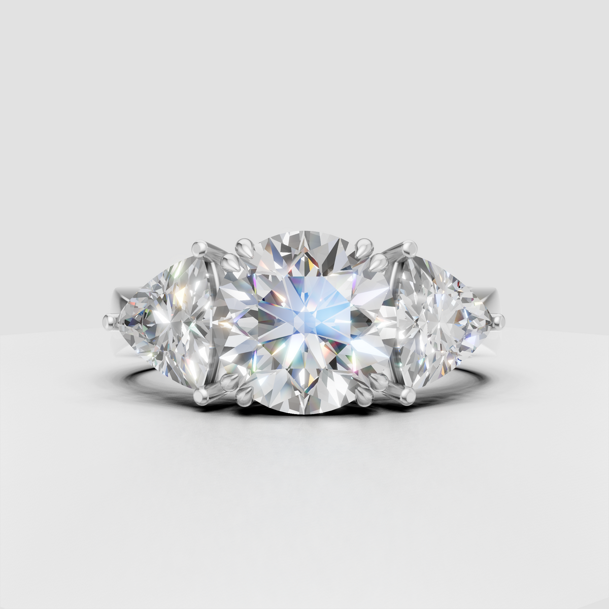 Round diamond ring with Trillion side stones in classic prong setting