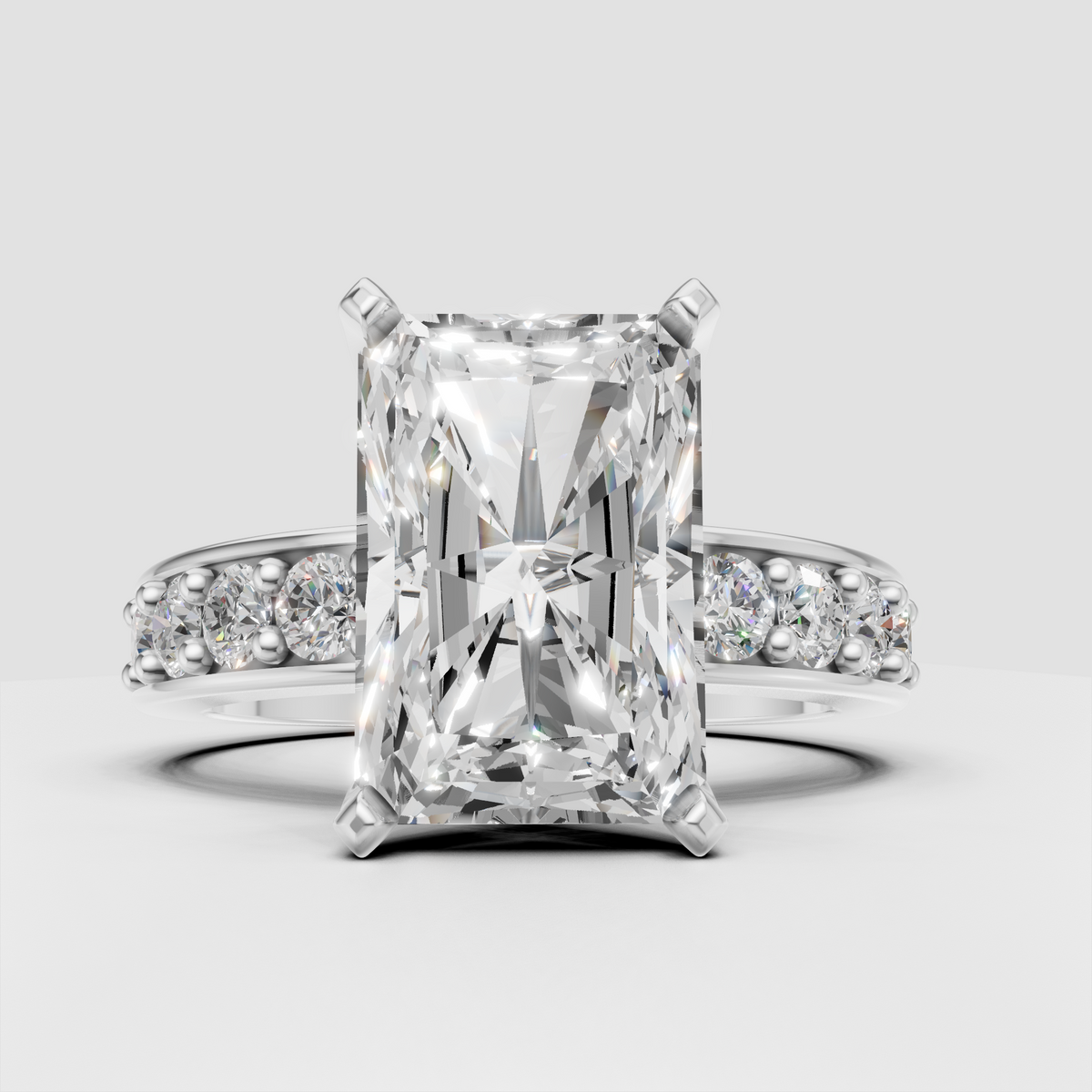 Yellow-gold radiant-cut engagement ring with channel-style side stones