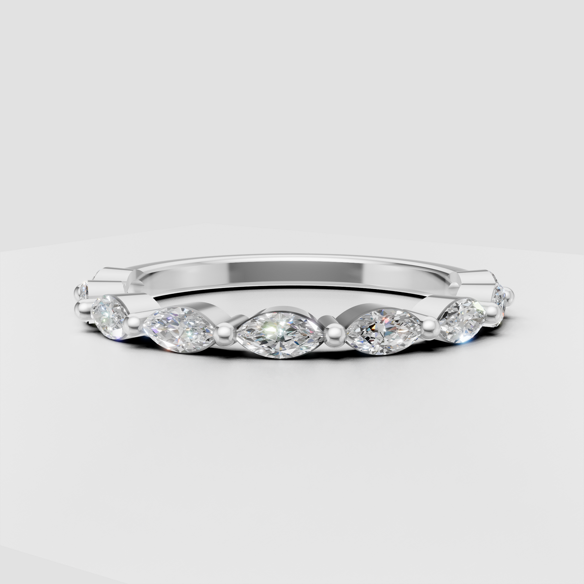 Bezel set marquise diamond eternity ring with polished gold accents