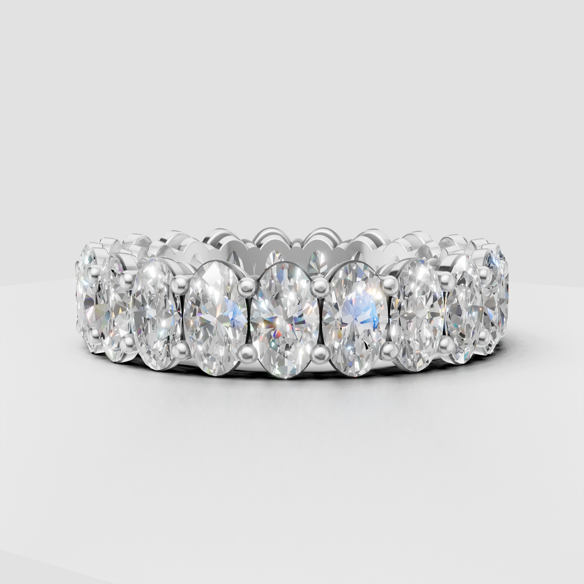Elegant oval diamond eternity ring with polished gold metal