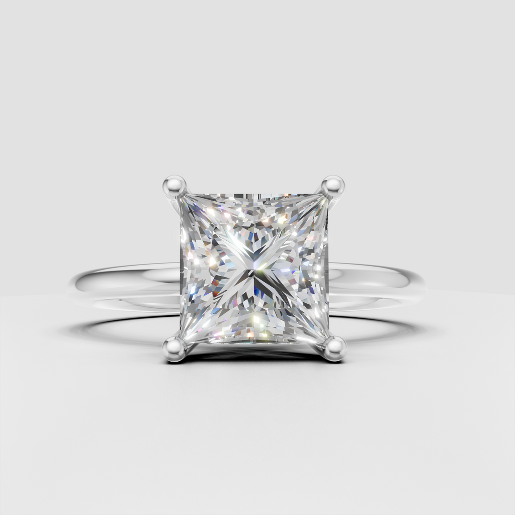 Side view of princess cut diamond solitaire ring showing four-prong setting and hidden accent diamonds