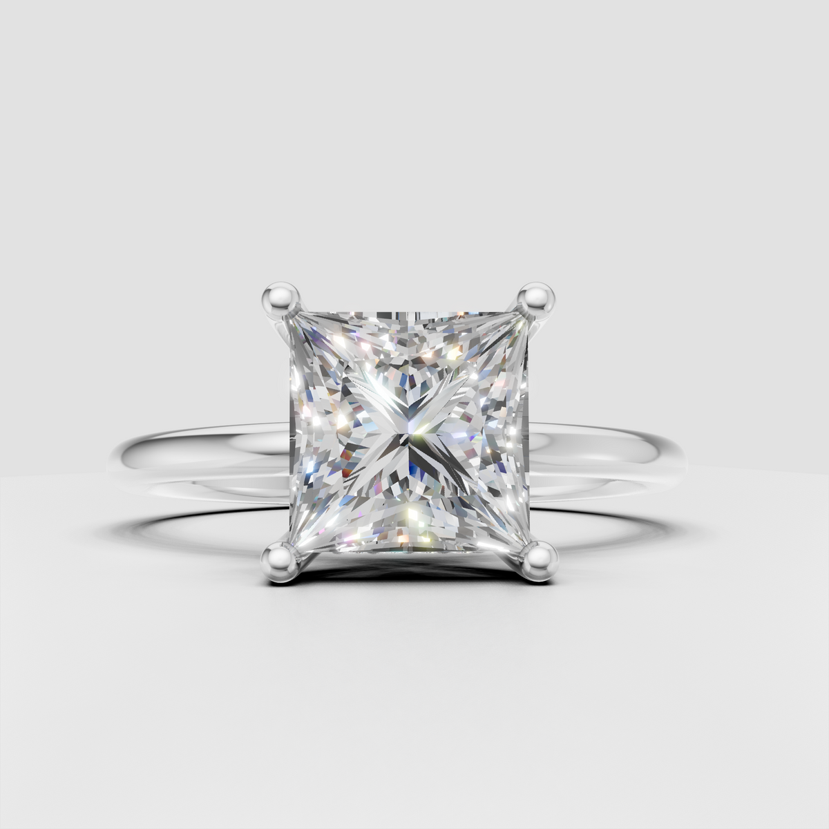 Side view of princess cut diamond solitaire ring showing four-prong setting and hidden accent diamonds