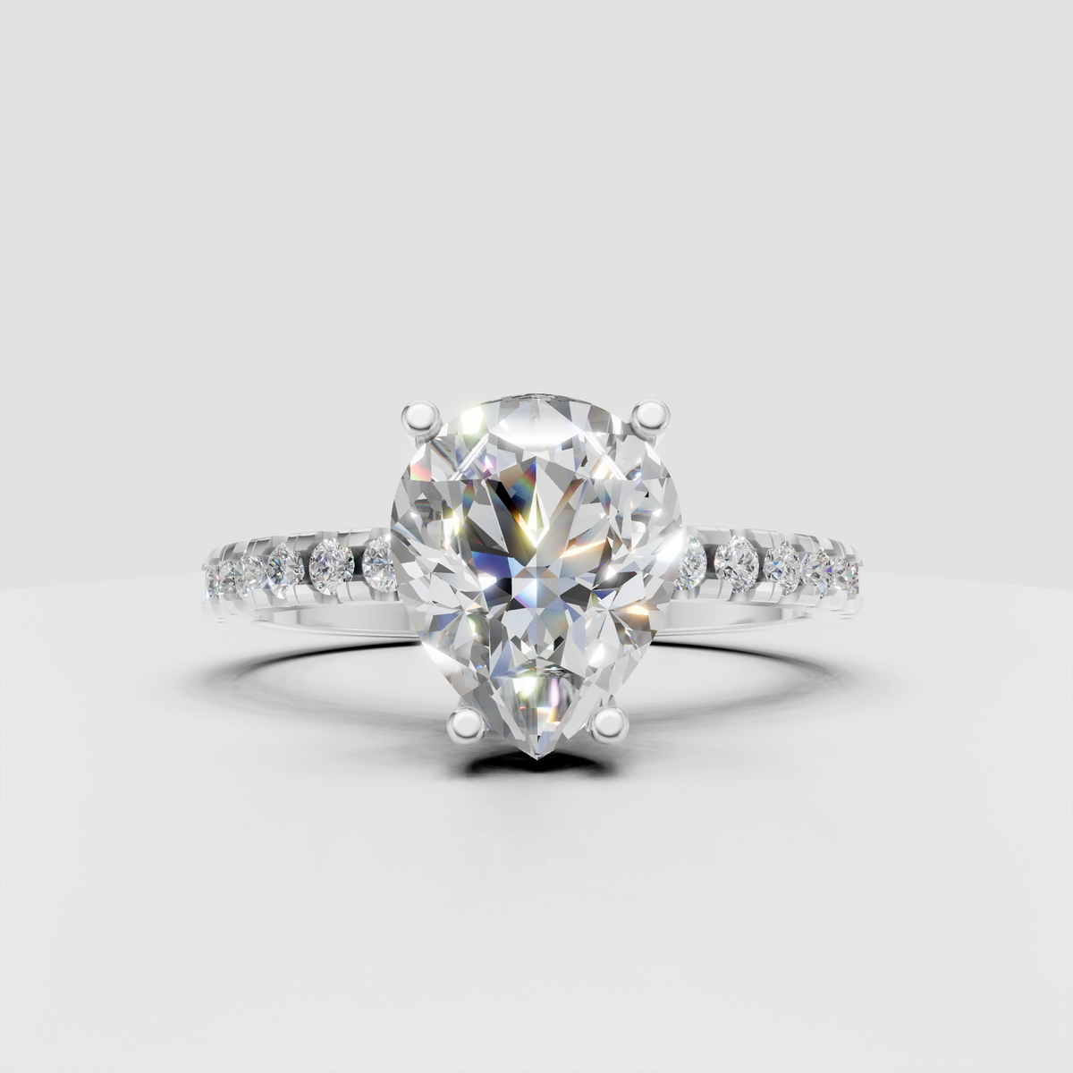 Pear diamond engagement ring featuring elevated basket setting
