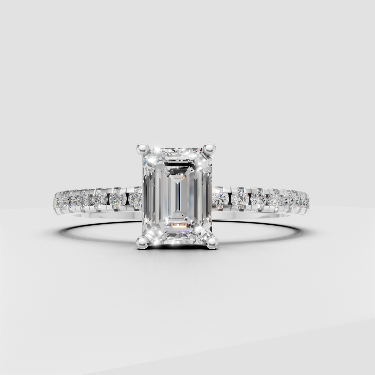 Emerald cut canter stone engagement ring with round pavé diamonds