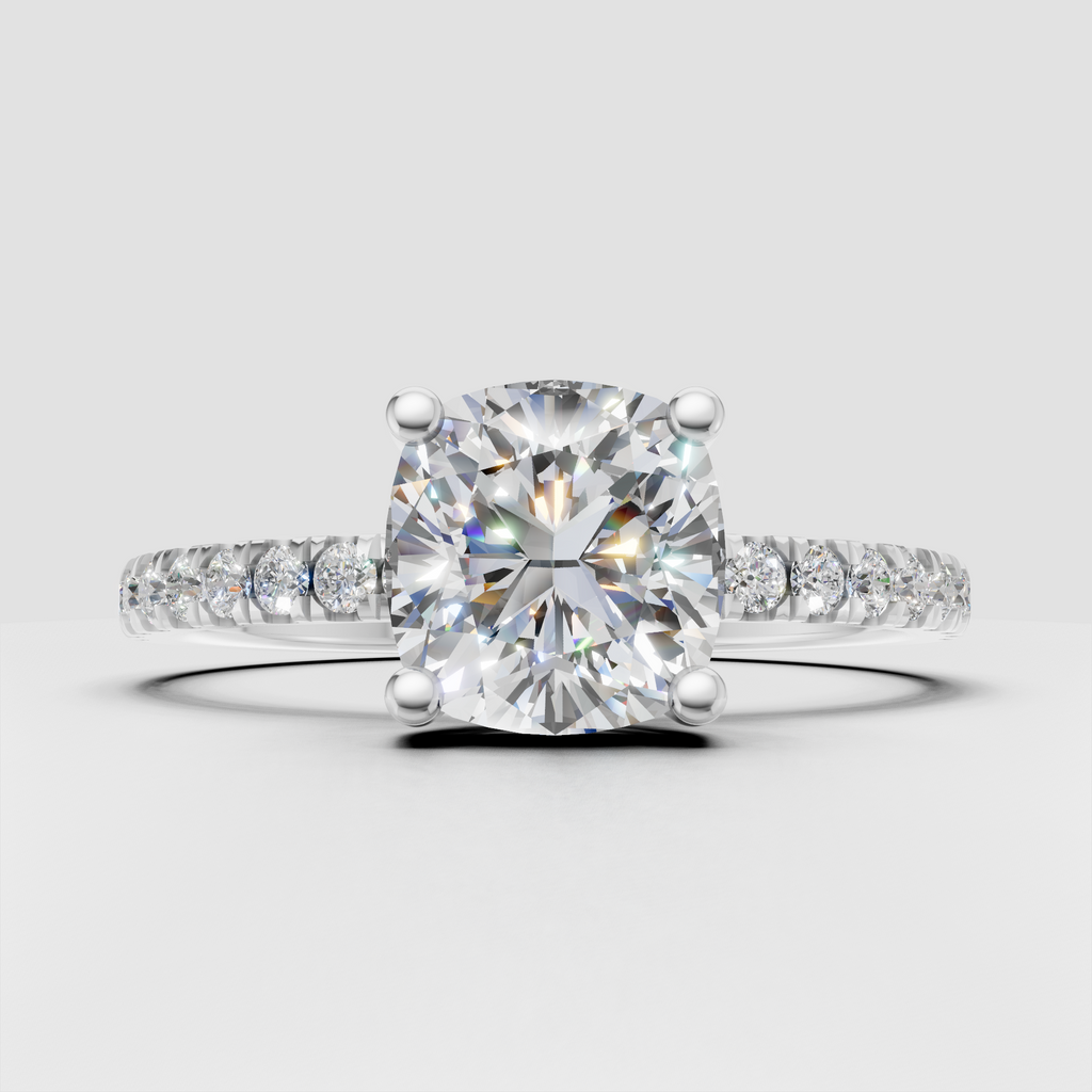 Cushion cut center diamond secured by rounded prongs
