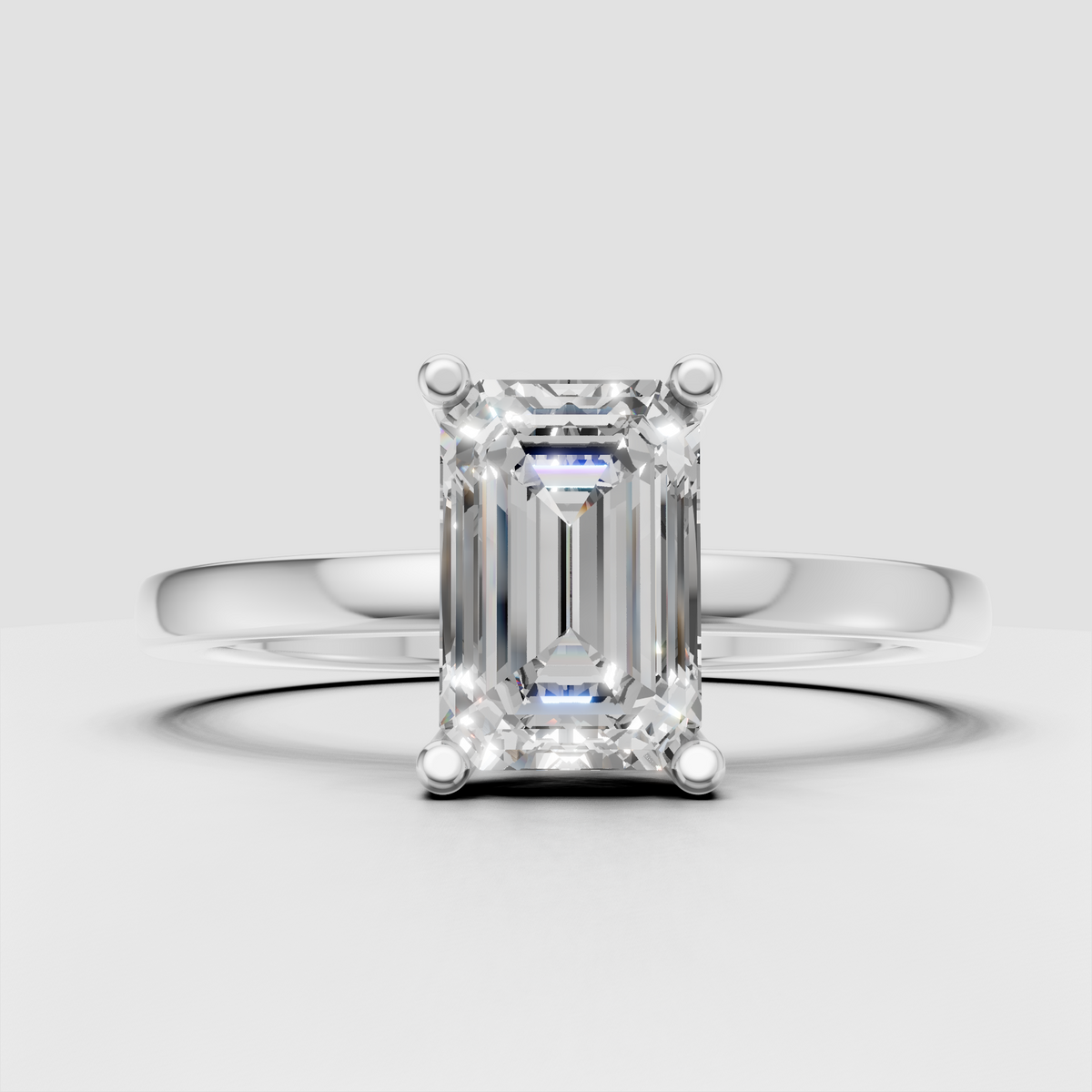 Rectangular emerald cut diamond solitaire in polished metal